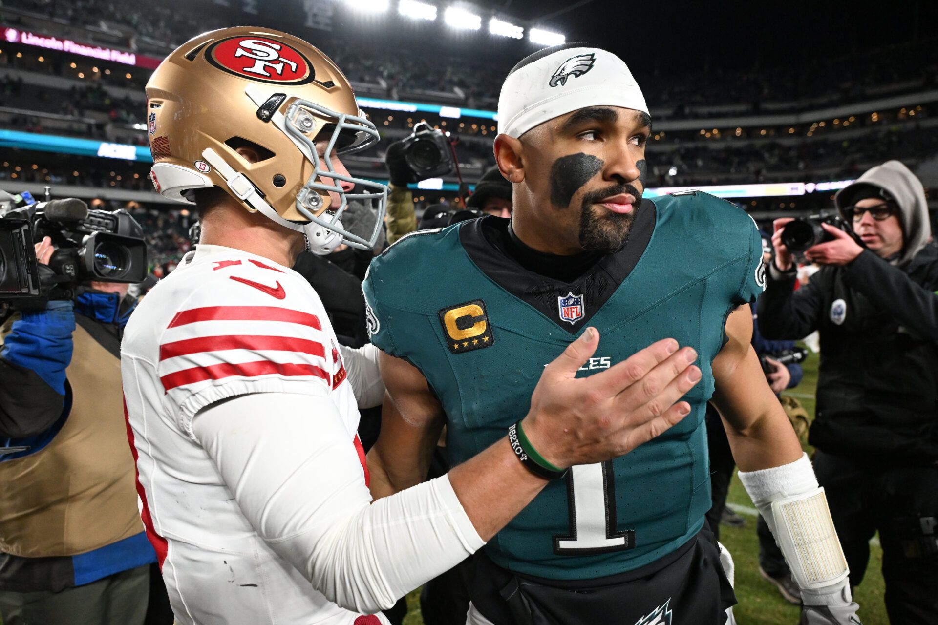 San Francisco 49ers quarterback Brock Purdy (13) speaks with Philadelphia Eagles quarterback Jalen Hurts (1) after an NFC Wild Card Round game at Lincoln Financial Field.
