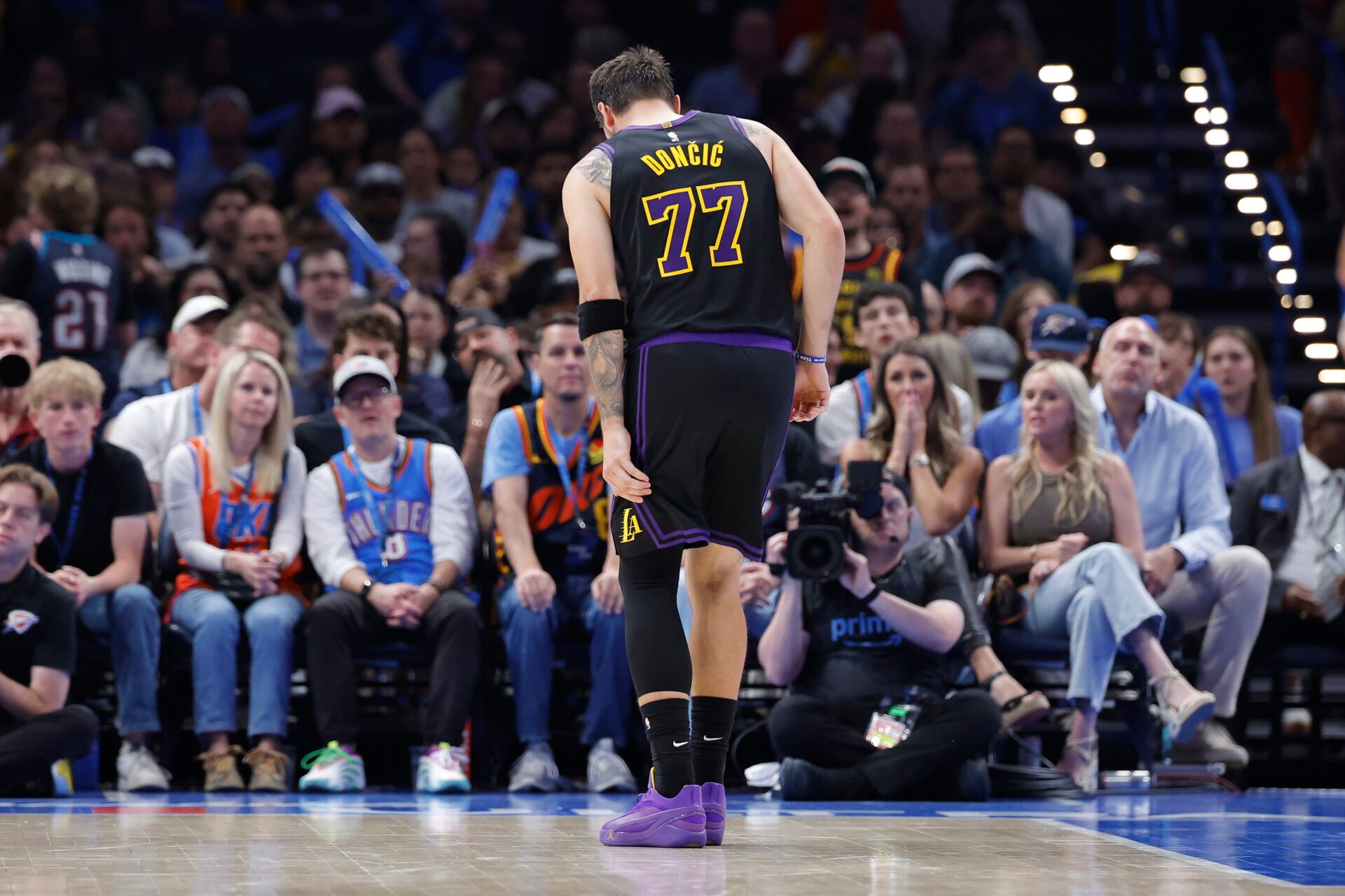 Los Angeles Lakers guard Luka Doncic (77) hops to the side of the court during a play against the Oklahoma City Thunder during the second half at Paycom Center.