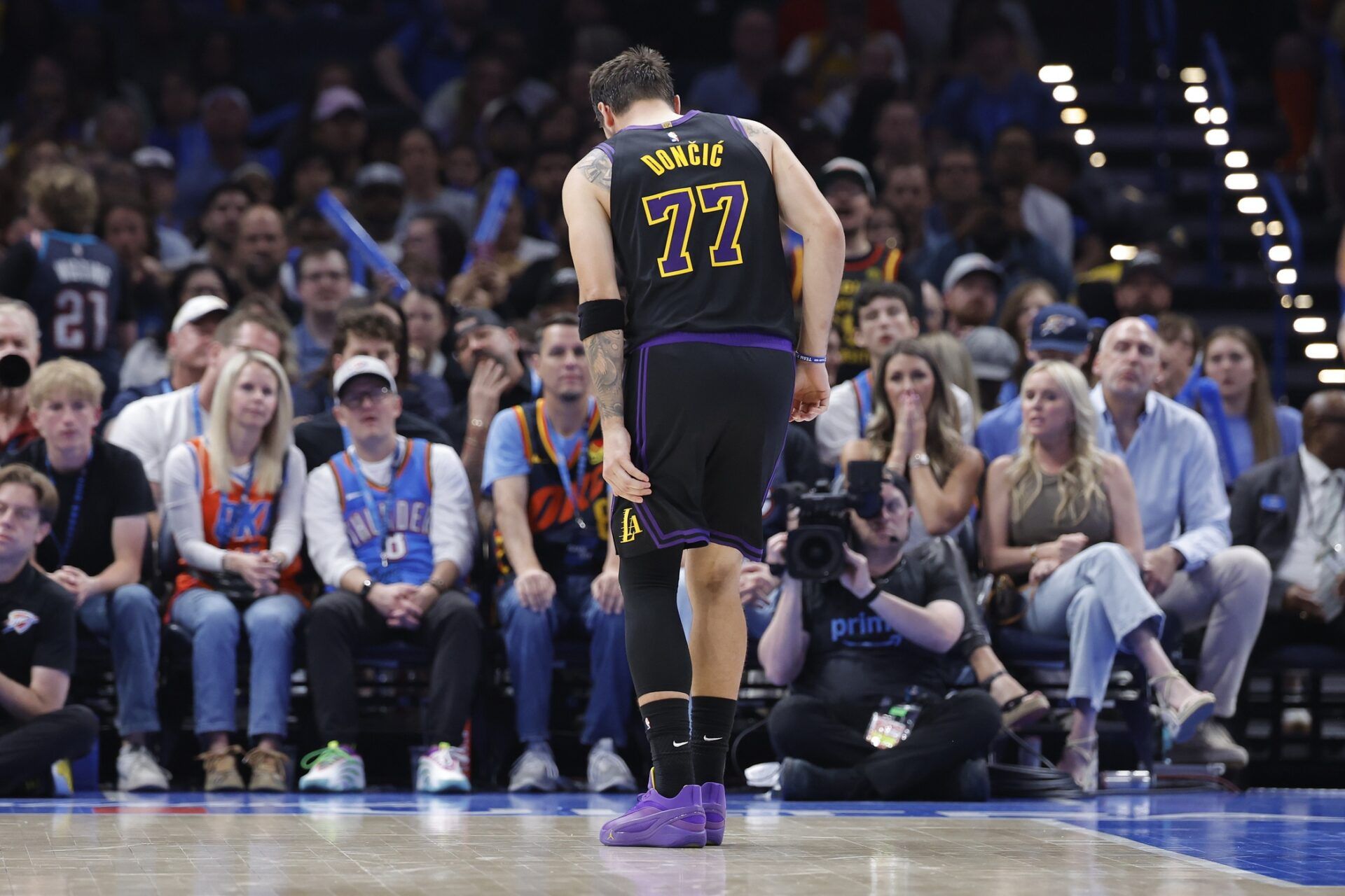 Los Angeles Lakers guard Luka Doncic (77) hops to the side of the court during a play against the Oklahoma City Thunder during the second half at Paycom Center.