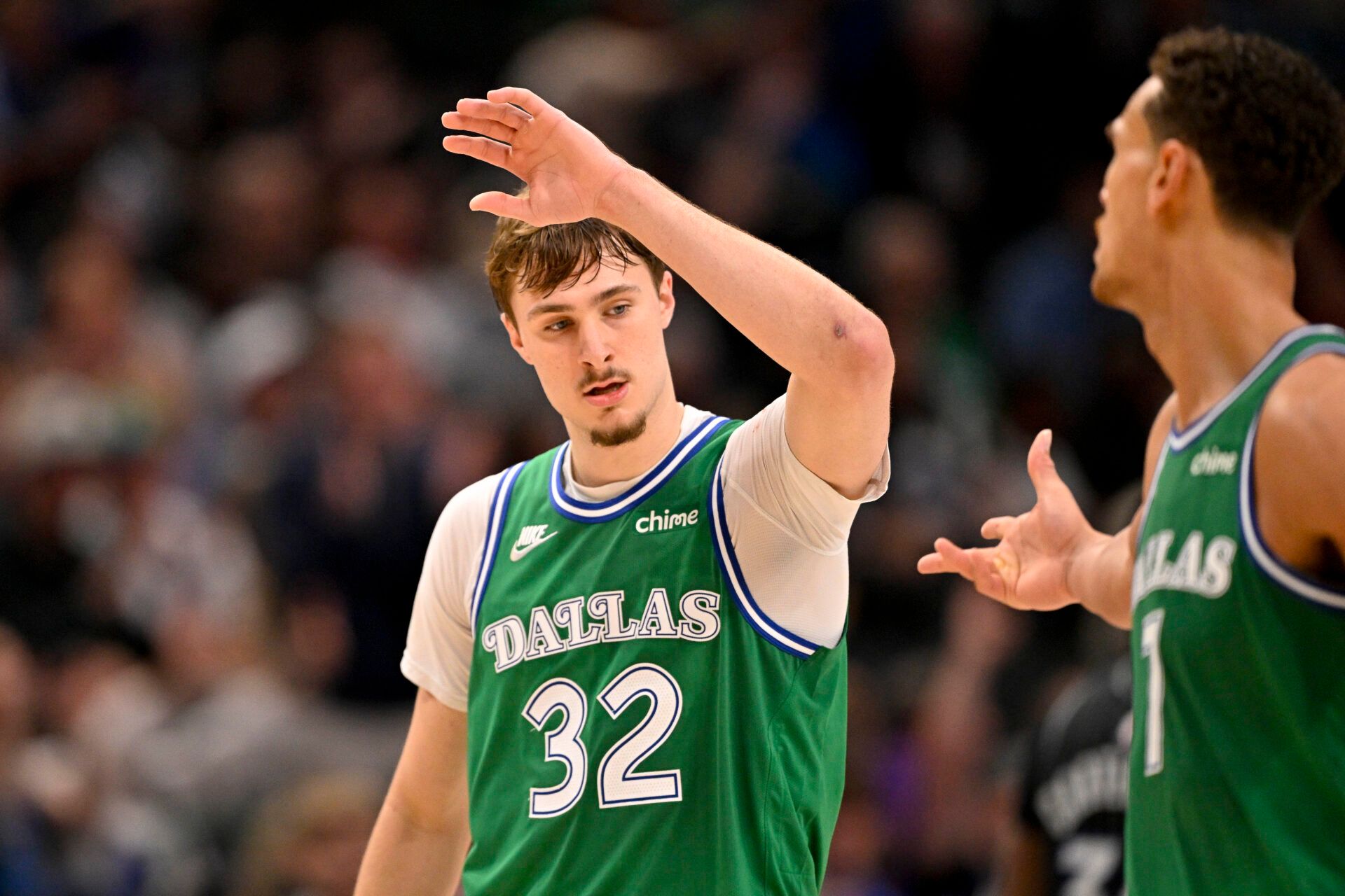 Dallas Mavericks forward Cooper Flagg (32) and forward Dwight Powell (7) celebrates Flagg making a three point basket against the Orlando Magic during the second half at the American Airlines Center.