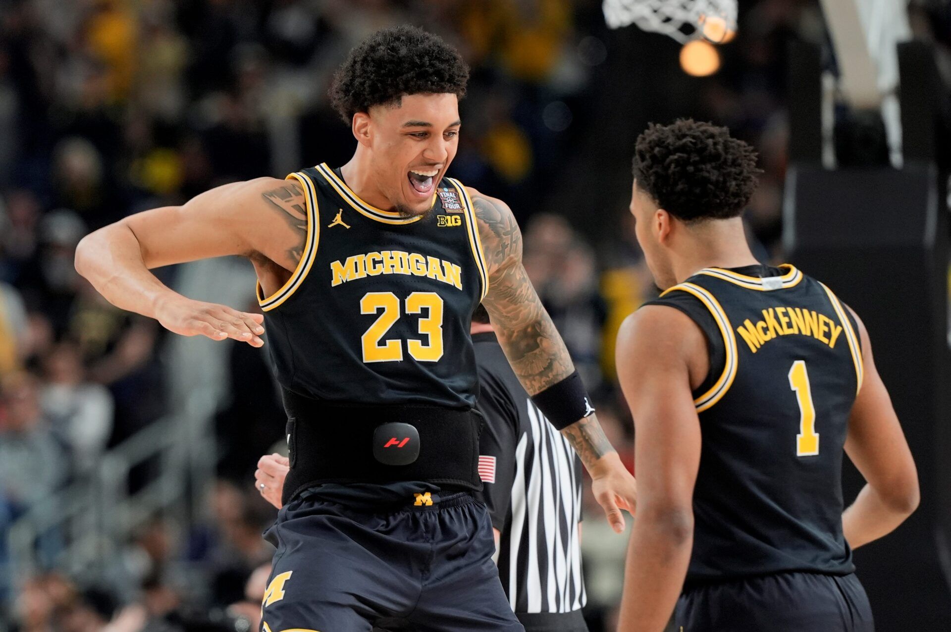 Michigan forward Yaxel Lendeborg (23) celebrates a play with Michigan guard Trey McKenney (1) in the first half of their Final Four game at Lucas Oil Stadium in Indianapolis on Saturday, April 4, 2026.