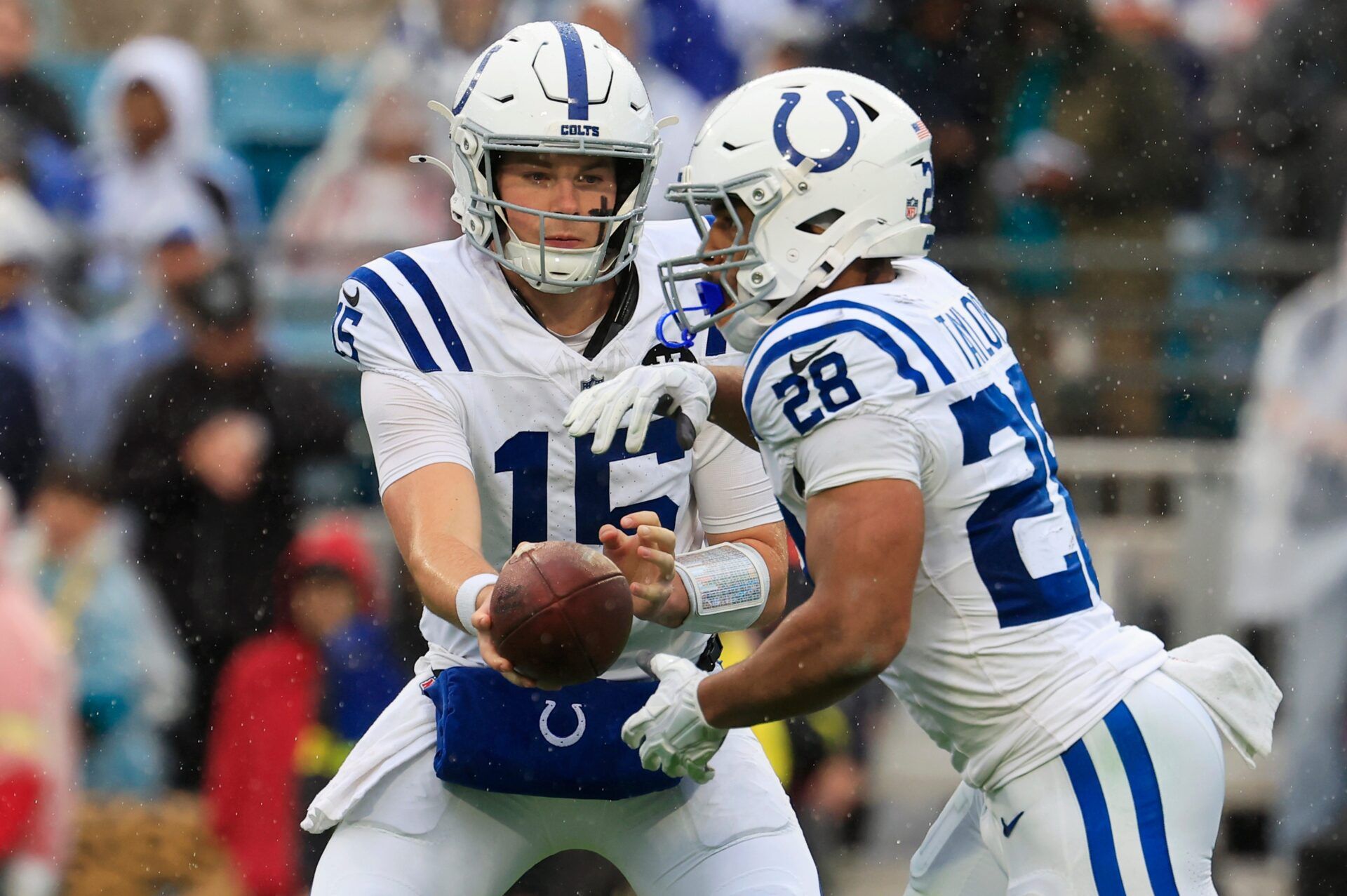 Indianapolis Colts quarterback Riley Leonard (15) looks to handoff to running back Jonathan Taylor (28) during the second quarter of an NFL football game at EverBank Stadium, Sunday, Dec. 7, 2025, in Jacksonville, Fla. The Jaguars defeated the Colts 36-19.