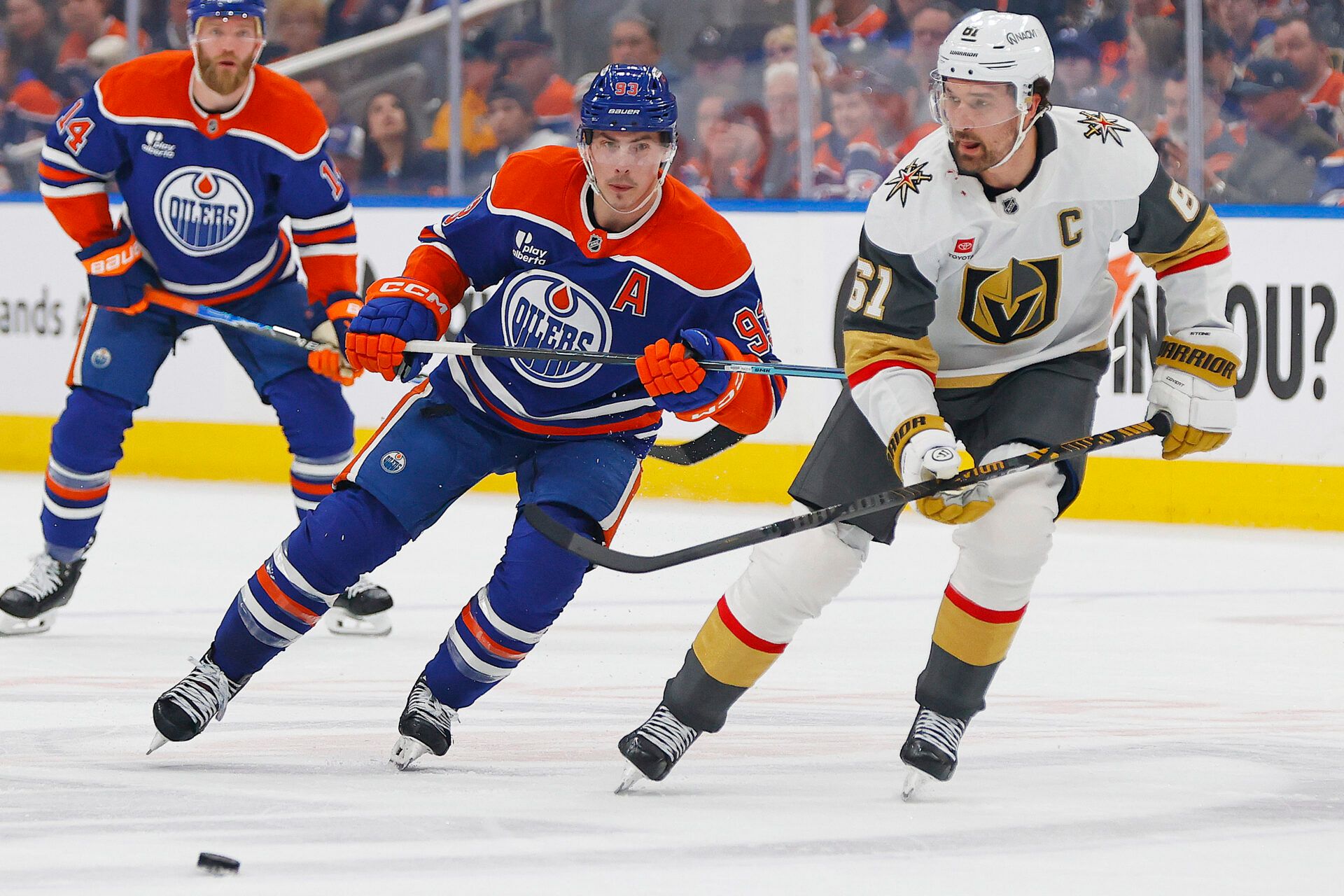 Edmonton Oilers forward Ryan Nugent-Hopkins (93) and Vegas Golden Knights forward Mark Stone (61) chase the puck during the first period at Rogers Place.