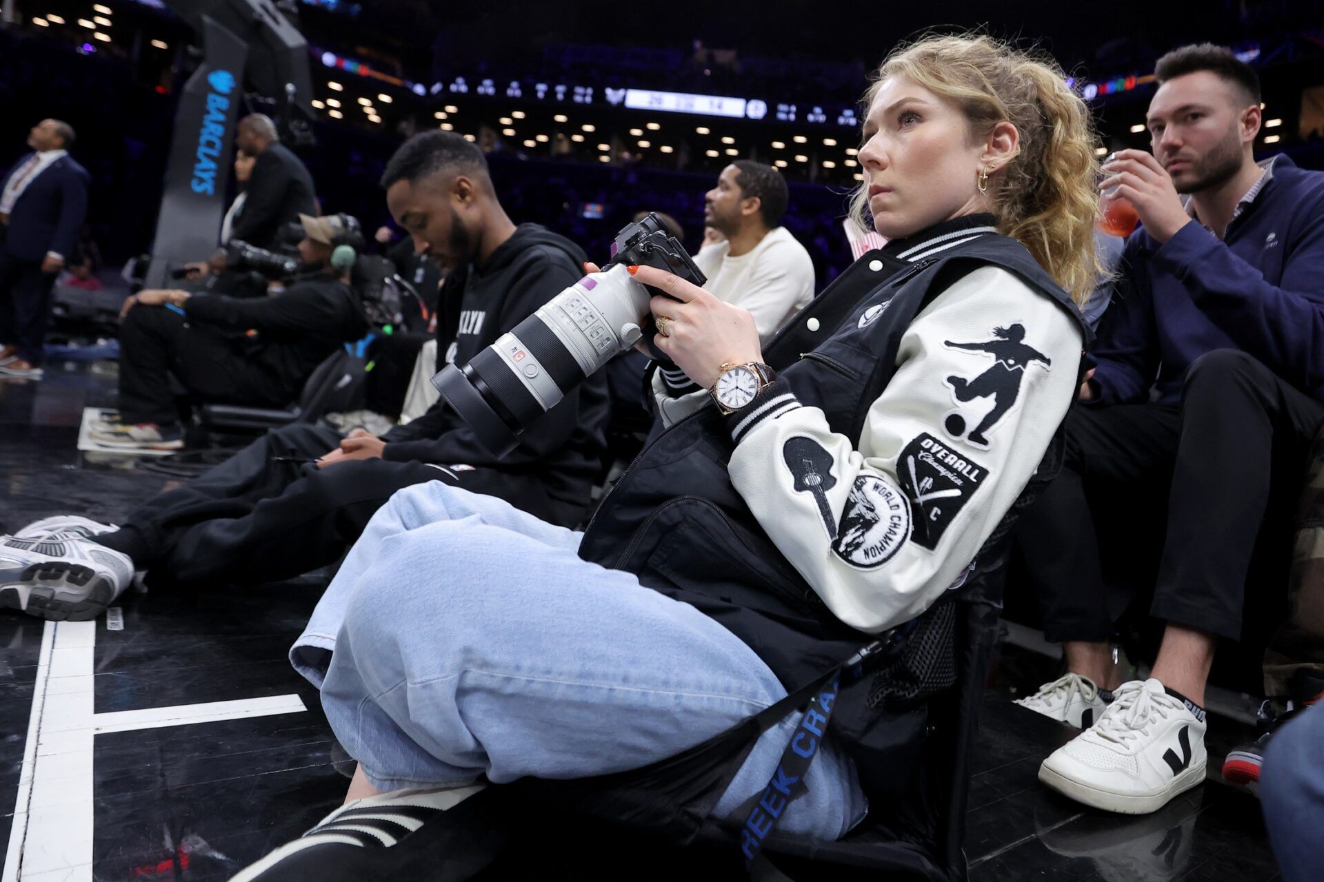 American alpine skier Mikaela Shiffrin photographs the game between the Brooklyn Nets and Charlotte Hornets court-side during the first quarter at Barclays Center.