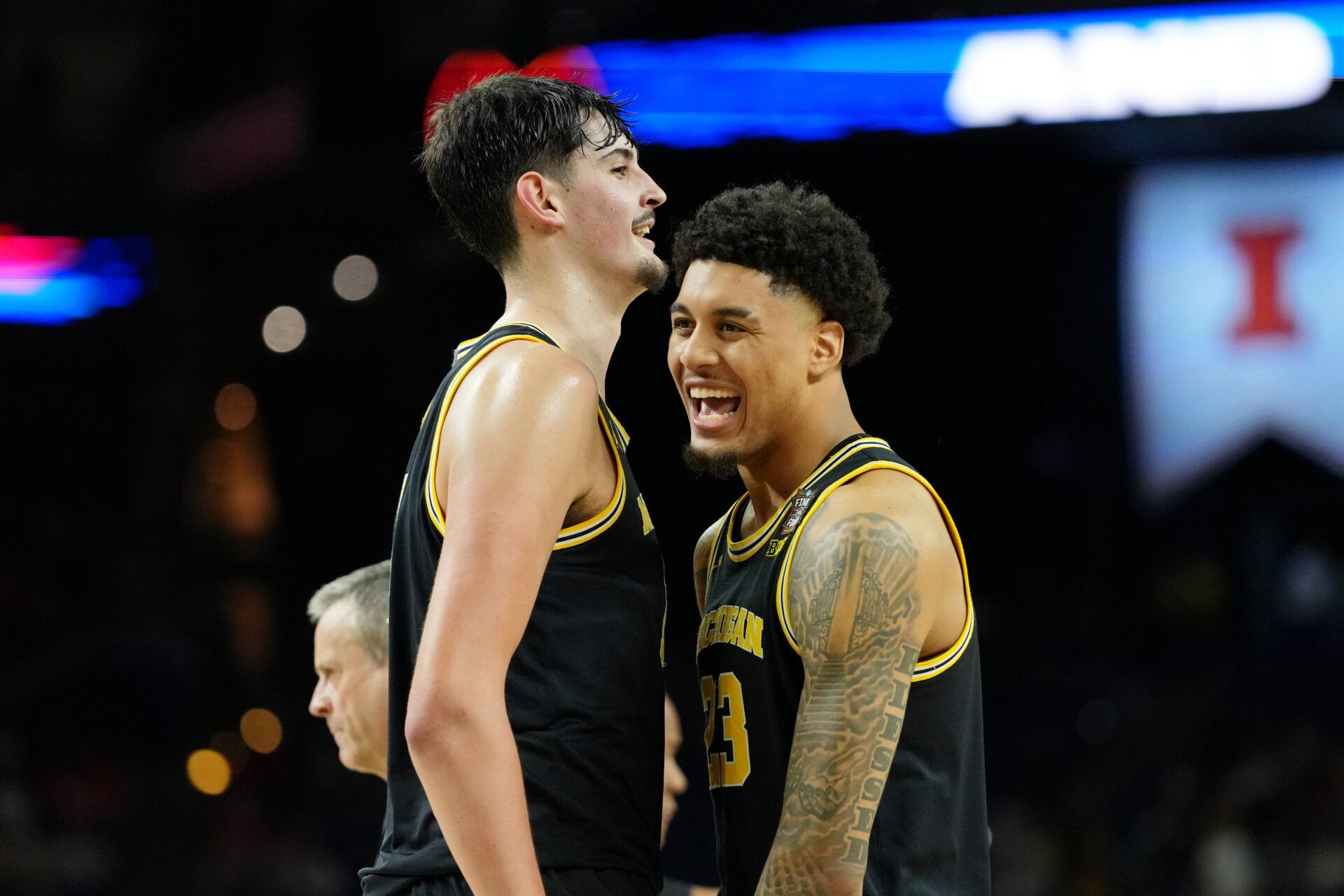 Michigan Wolverines center Aday Mara (15) and forward Yaxel Lendeborg (23) react during the second half in a semifinal of the Final Four of the men's 2026 NCAA Tournament at Lucas Oil Stadium.