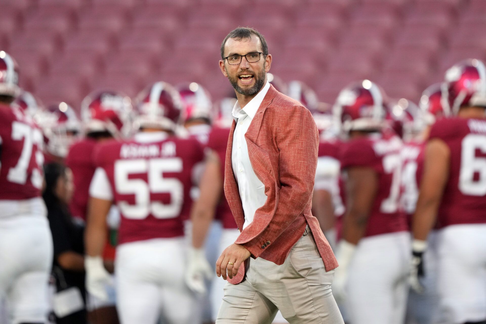 Stanford Cardinal general manager Andrew Luck walks on the field before the game against the Boston College Eagles at Stanford Stadium.