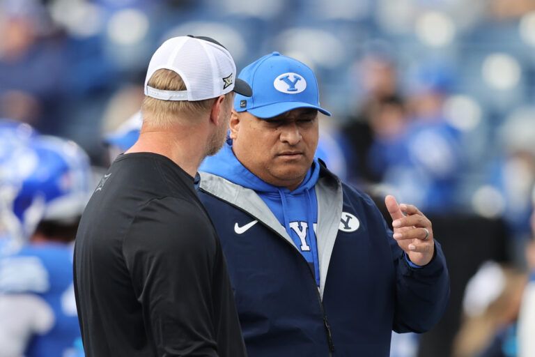 BYU Cougars head coach Kalani Sitake, right, speaks with UCF Knights head coach Scott Frost before the game at LaVell Edwards Stadium.