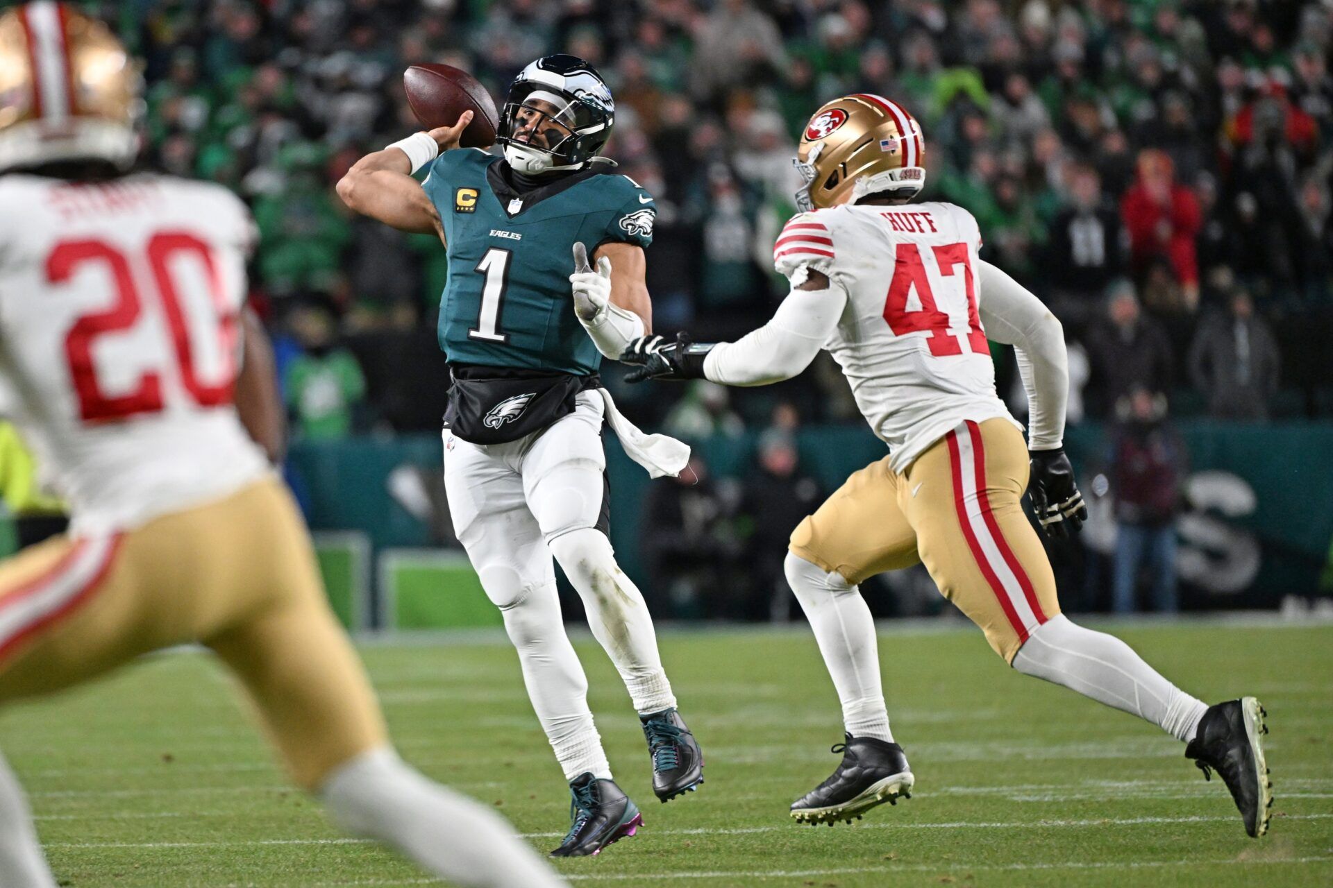 Philadelphia Eagles quarterback Jalen Hurts (1) runs under pressure from San Francisco 49ers defensive end Bryce Huff (47) during the fourth quarter in an NFC Wild Card Round game at Lincoln Financial Field.