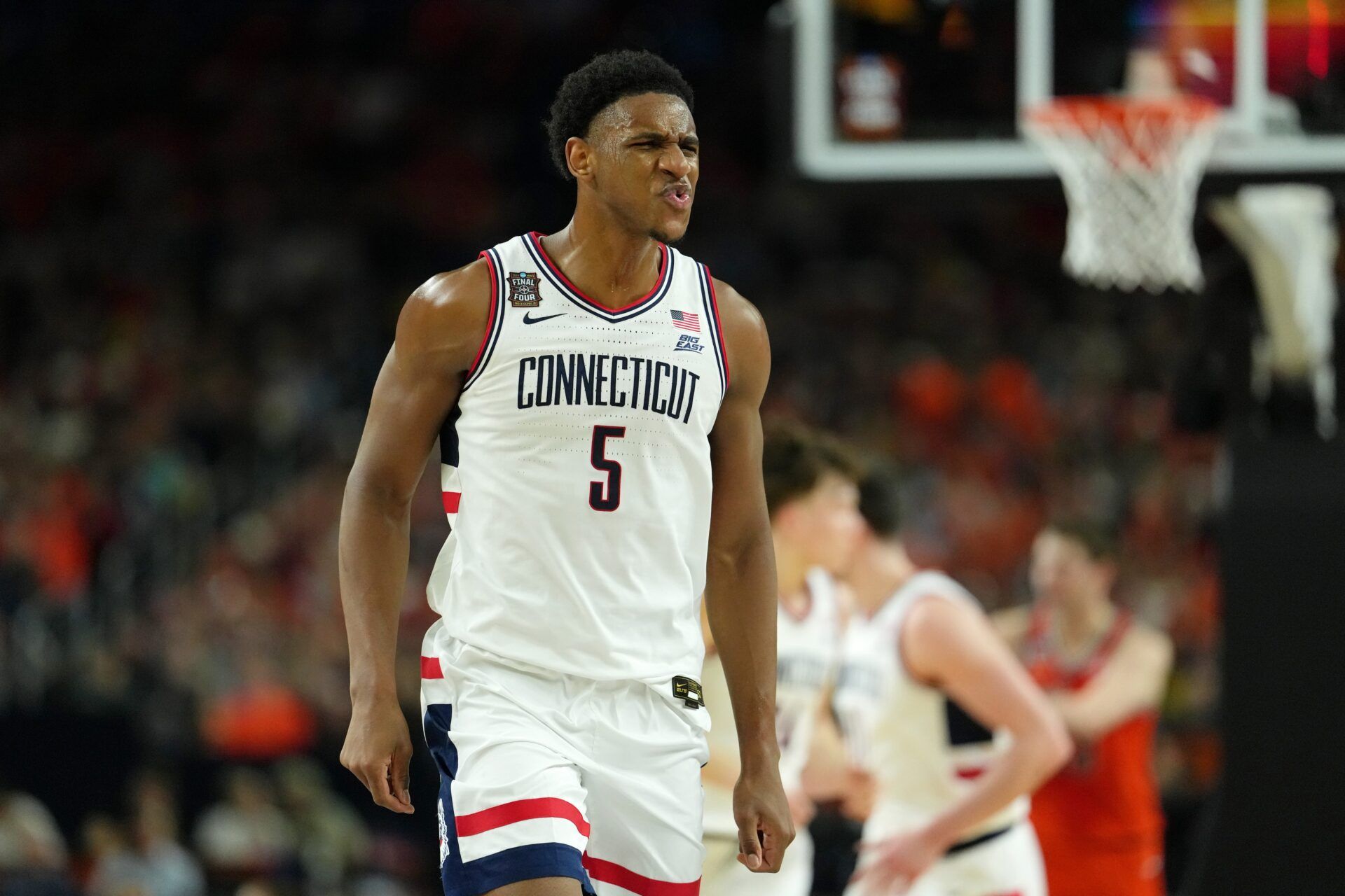 UConn Huskies forward Tarris Reed Jr. (5) reacts after a play against the Illinois Fighting Illini during the first half of a semifinal of the Final Four of the men's 2026 NCAA Tournament at Lucas Oil Stadium.
