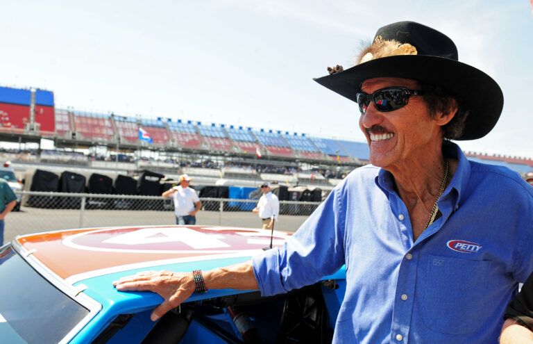 NASCAR Sprint Cup Series former driver Richard Petty with the car he won his 200th career race with during practice for the Aarons 499 at Talladega Superspeedway.