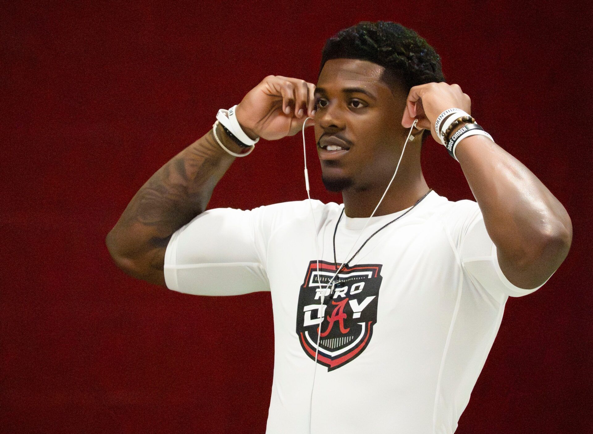 Wide receiver Germie Bernard puts in his ear buds as he warms up during Pro Day in the Hank Crisp Indoor Practice Facility at the University of Alabama.