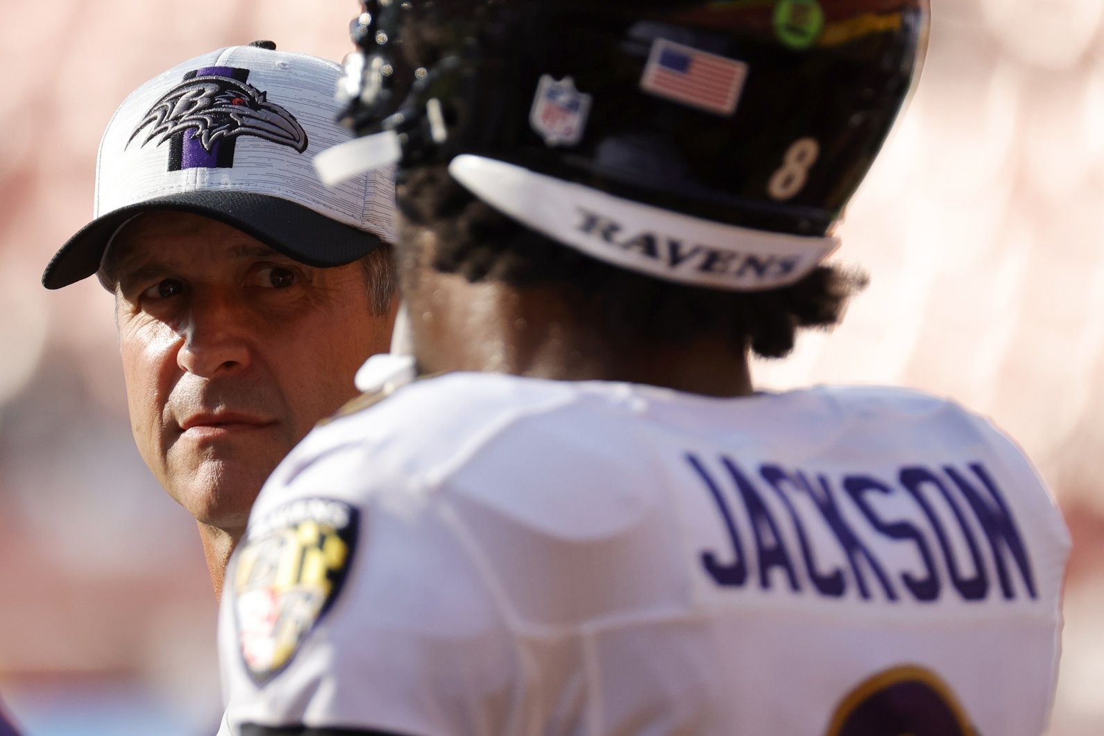 Baltimore Ravens head coach John Harbaugh (L) talks with Ravens quarterback Lamar Jackson (8) during warmups prior to their game against the Washington Football Team at FedExField.