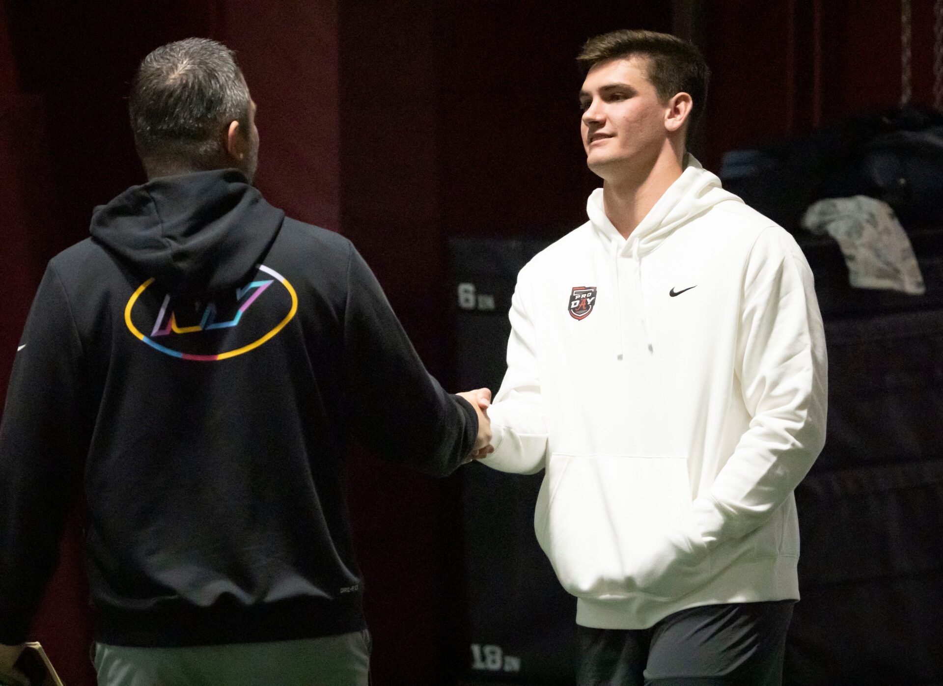 Quarterback Ty Simpson talks to a scout during Pro Day in the Hank Crisp Indoor Practice Facility at the University of Alabama.