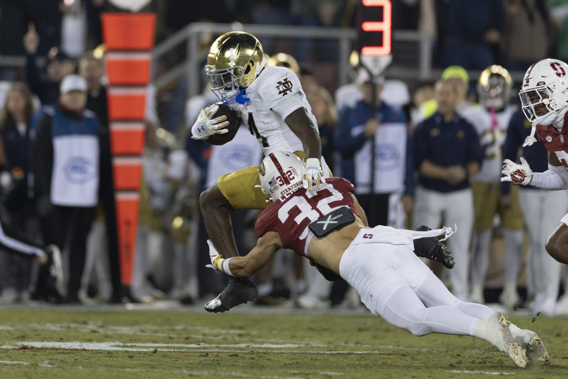 Notre Dame Fighting Irish running back Jeremiyah Love (4) attempts to run past Stanford Cardinal safety Mitch Leigber (32) during the first quarter at Stanford Stadium.