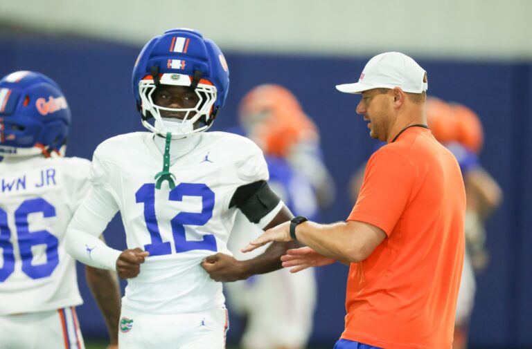 Florida head coach Jon Sumrall talks with Florida cornerback Ben Hanks II (12) during practice during spring practice at Sanders Practice Fields in Gainesville, FL on Thursday, April 2, 2026. [Alan Youngblood/Gainesville Sun]