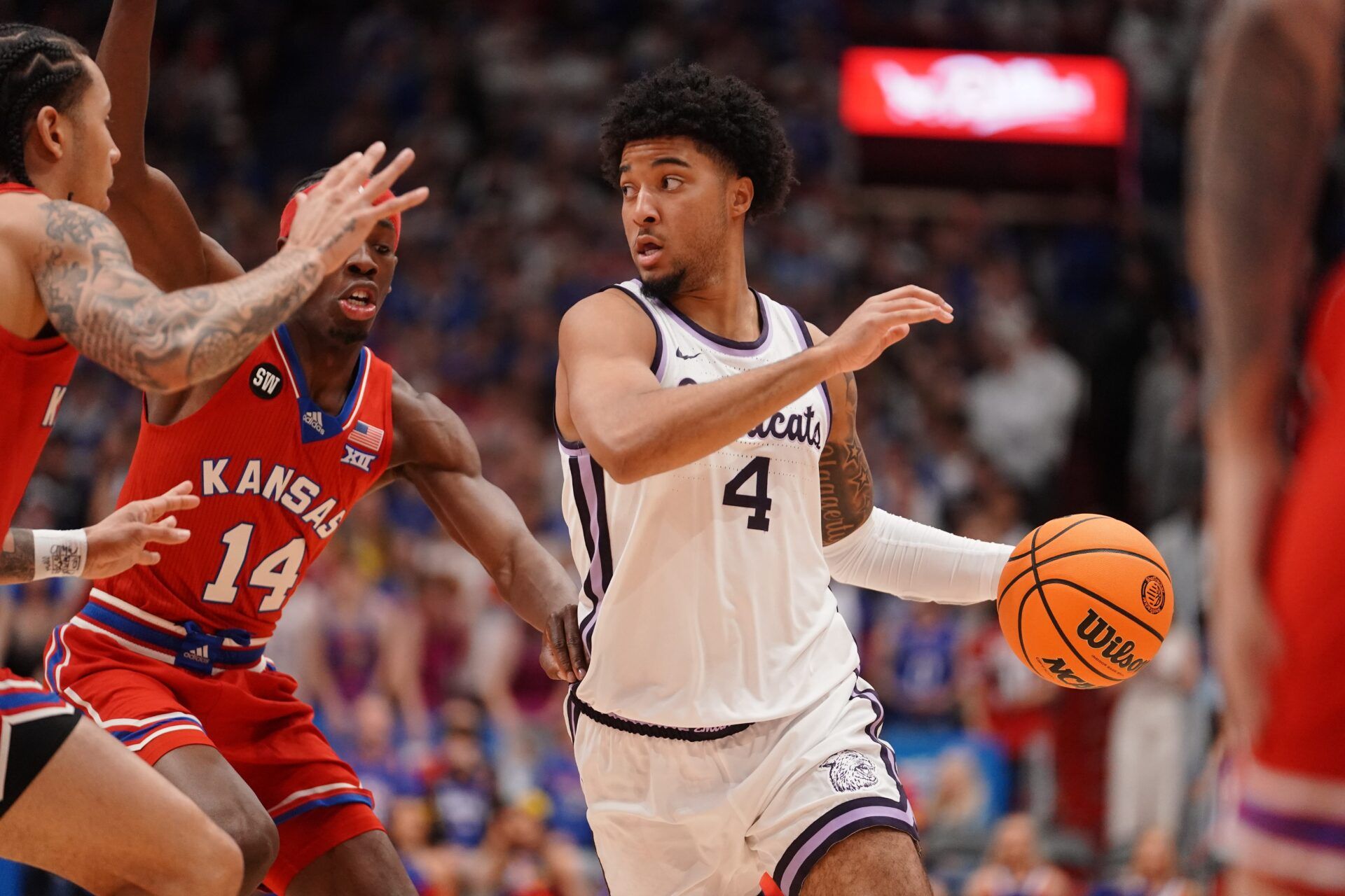 Kansas State Wildcats guard PJ Haggerty (4) drives the ball against Kansas Jayhawks during the Sunflower Showdown game inside Allen Fieldhouse in Lawrence, Kansas, on Saturday, March 7, 2026.