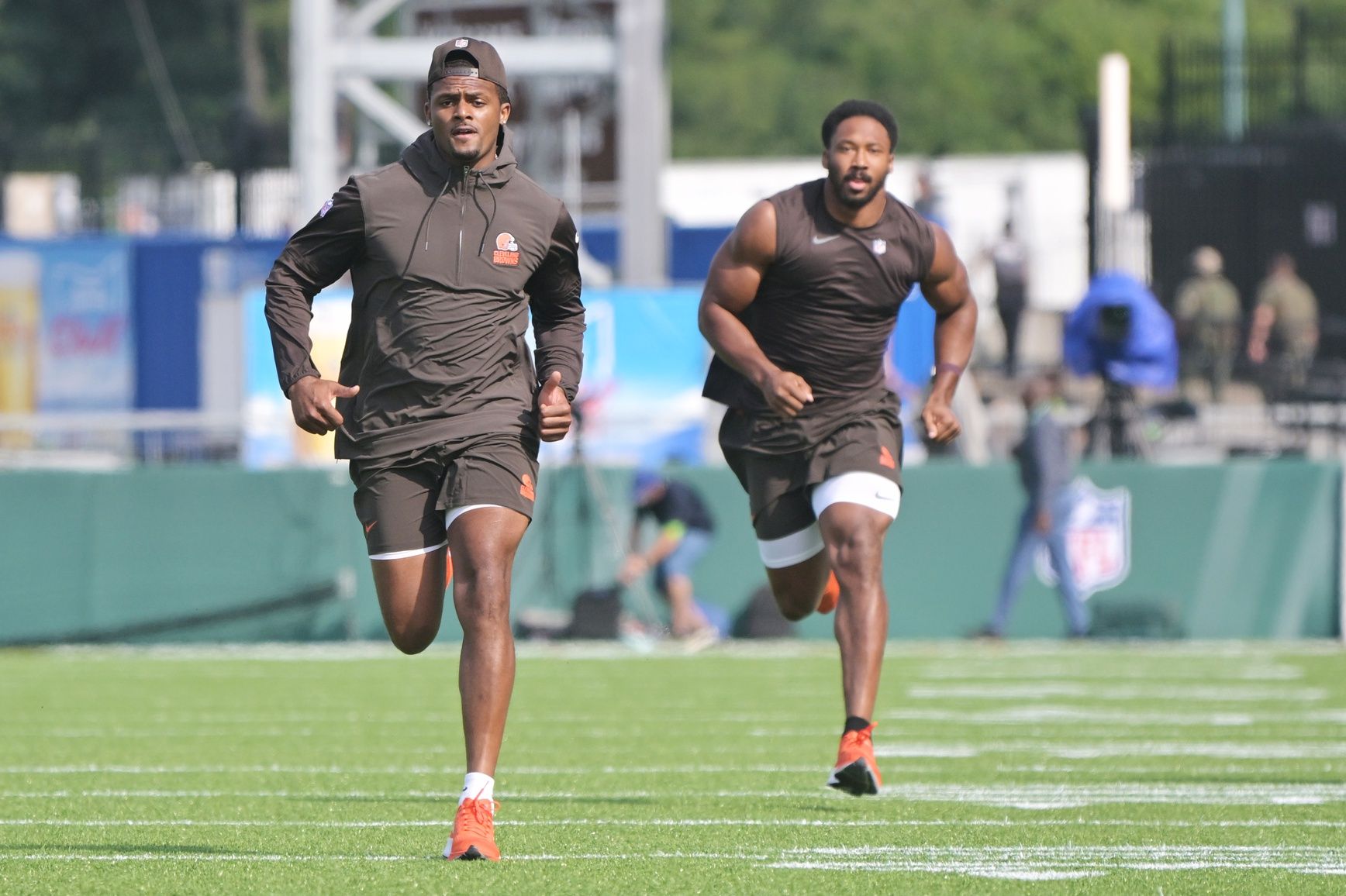 Cleveland Browns quarterback Deshaun Watson, left, and defensive end Myles Garrett warm up before the game between the Browns and the New York Jets at Tom Benson Hall of Fame Stadium.