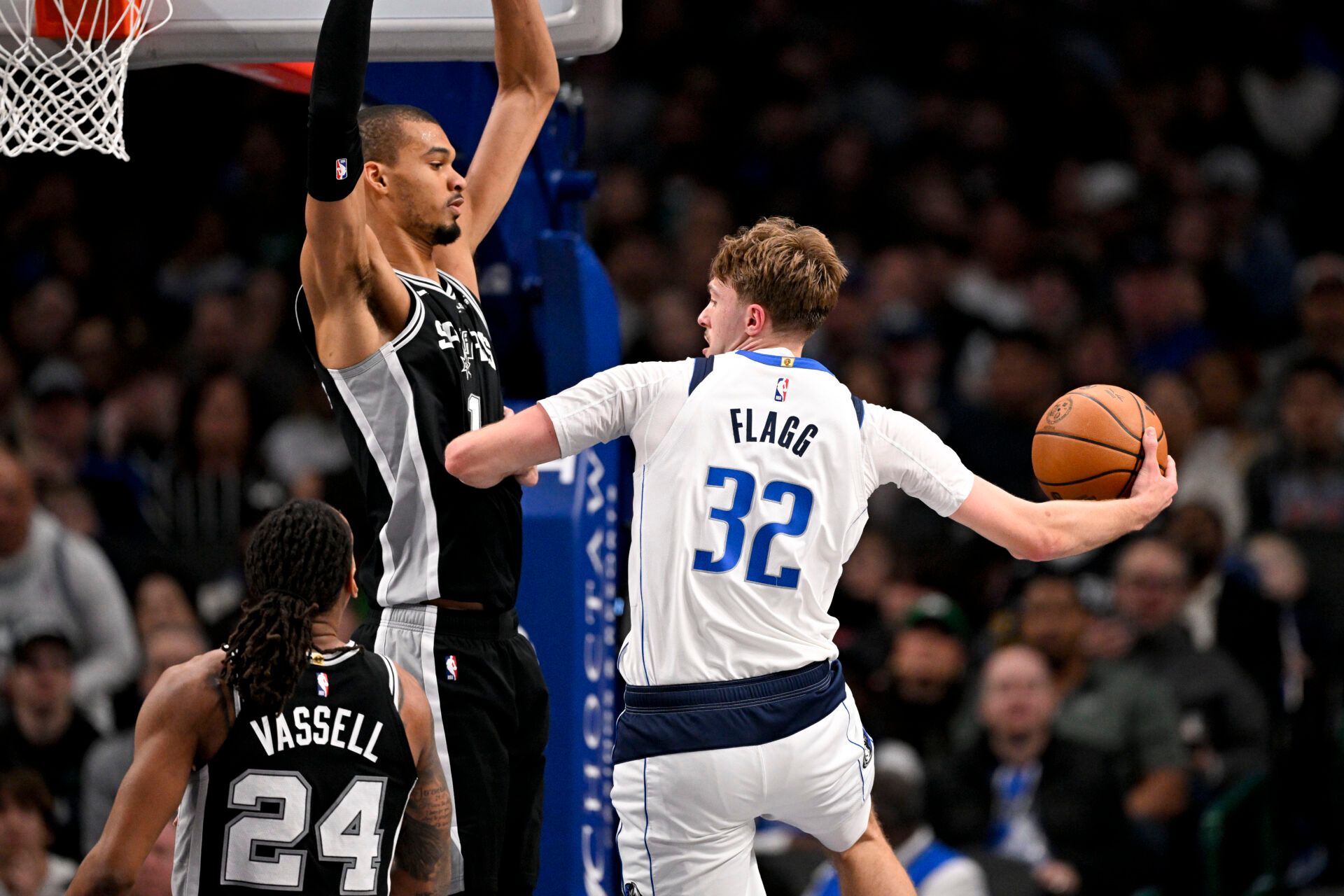 Dallas Mavericks forward Cooper Flagg (32) passes the ball by San Antonio Spurs forward Victor Wembanyama (1) during the second half at the American Airlines Center.