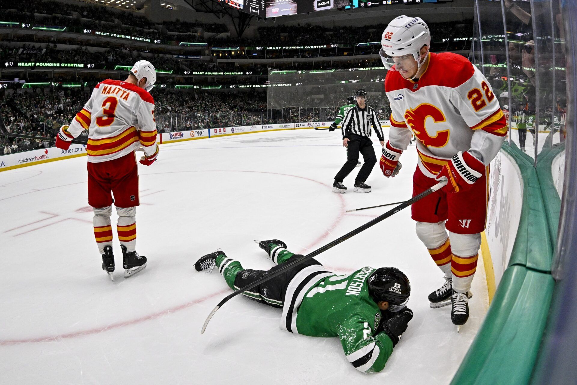 Calgary Flames center Ryan Strome (22) stands over Dallas Stars left wing Jason Robertson (21) after Strome draws a four minute penalty for high sticking during the overtime period at the American Airlines Center.