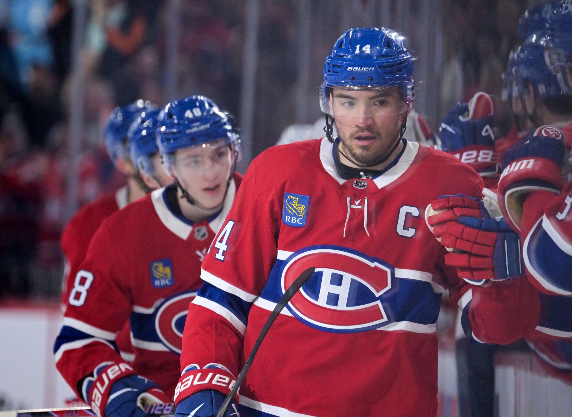 Montreal Canadiens forward Nick Suzuki (14) celebrates with teammates after scoring a goal against the Florida Panthers during the third period at the Bell Centre.