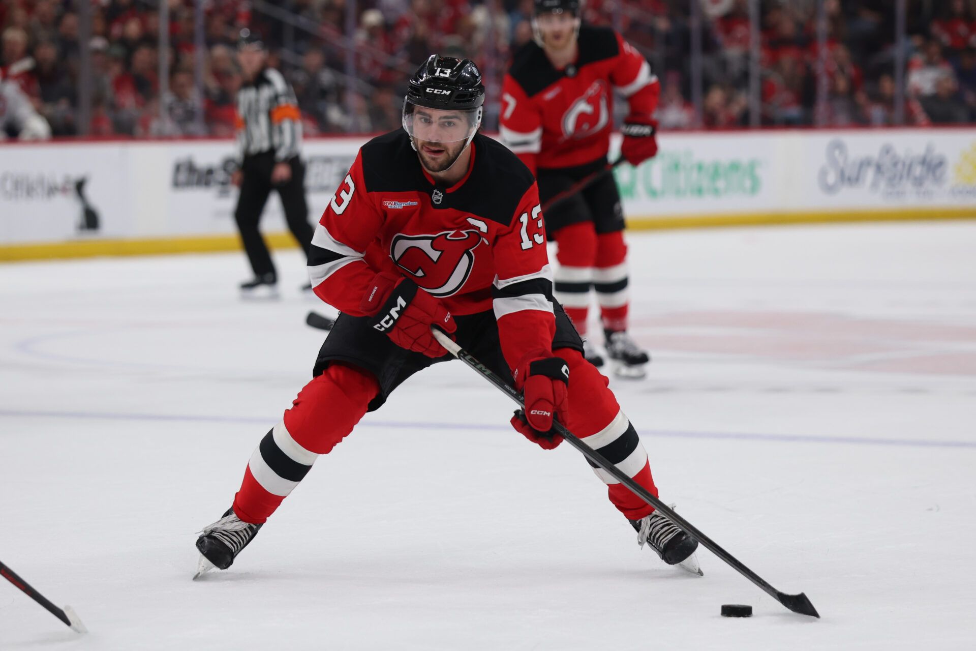 New Jersey Devils center Nico Hischier (13) controls the puck against the Montréal Canadiens during overtime at Prudential Center.