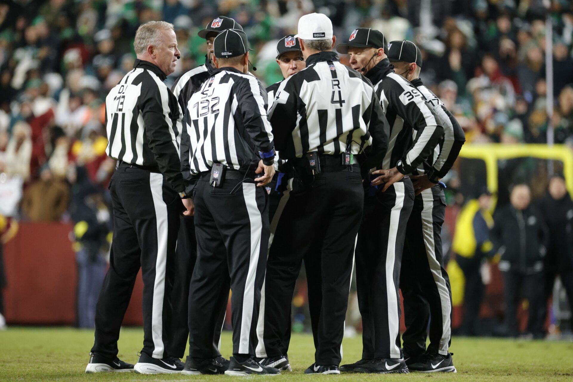 Referees talk on the field after a fight between the Washington Commanders and the Philadelphia Eagles during the second half at Northwest Stadium.