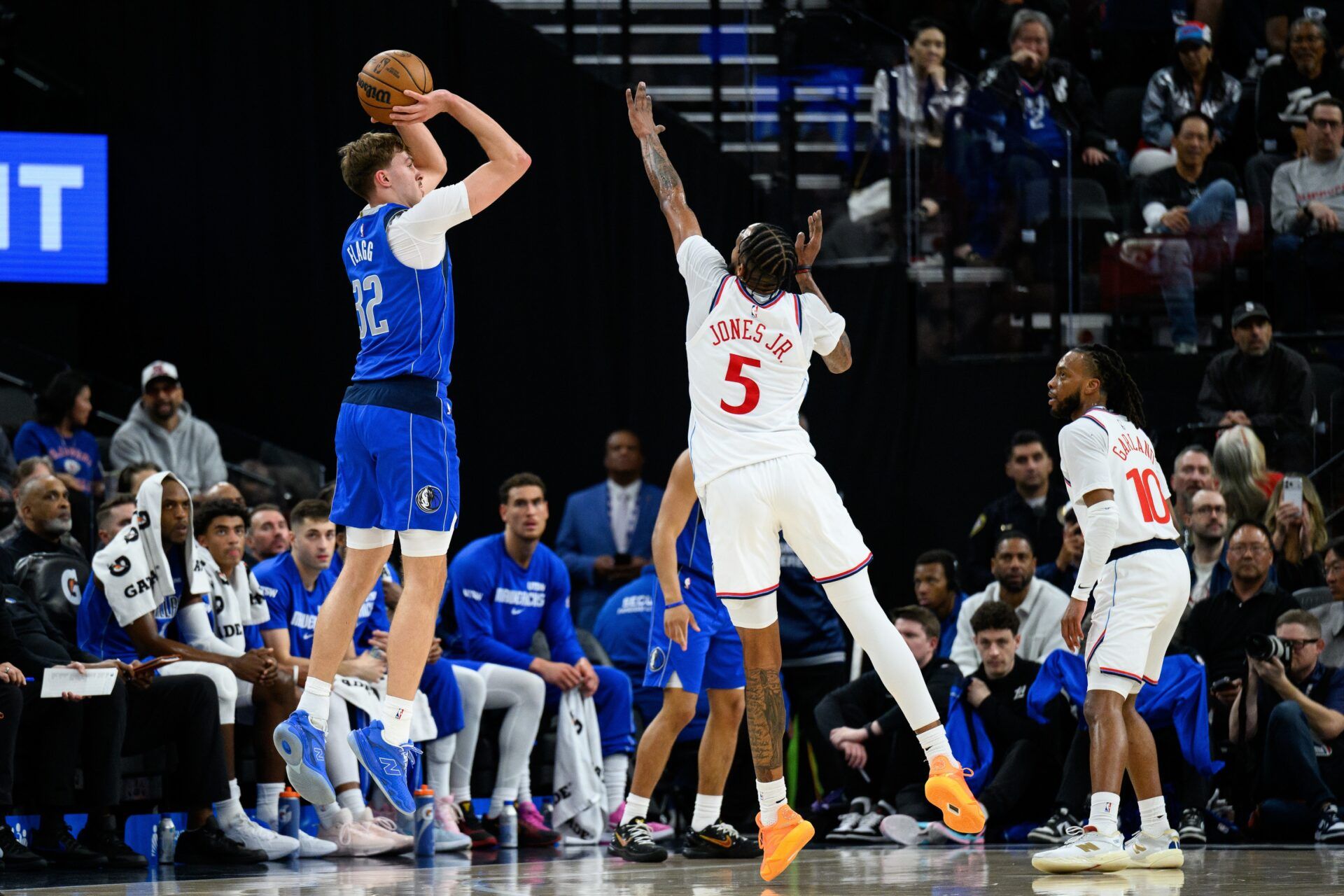 Dallas Mavericks forward Cooper Flagg (32) shoots over Los Angeles Clippers forward Derrick Jones Jr. (5) during the first half at Intuit Dome.
