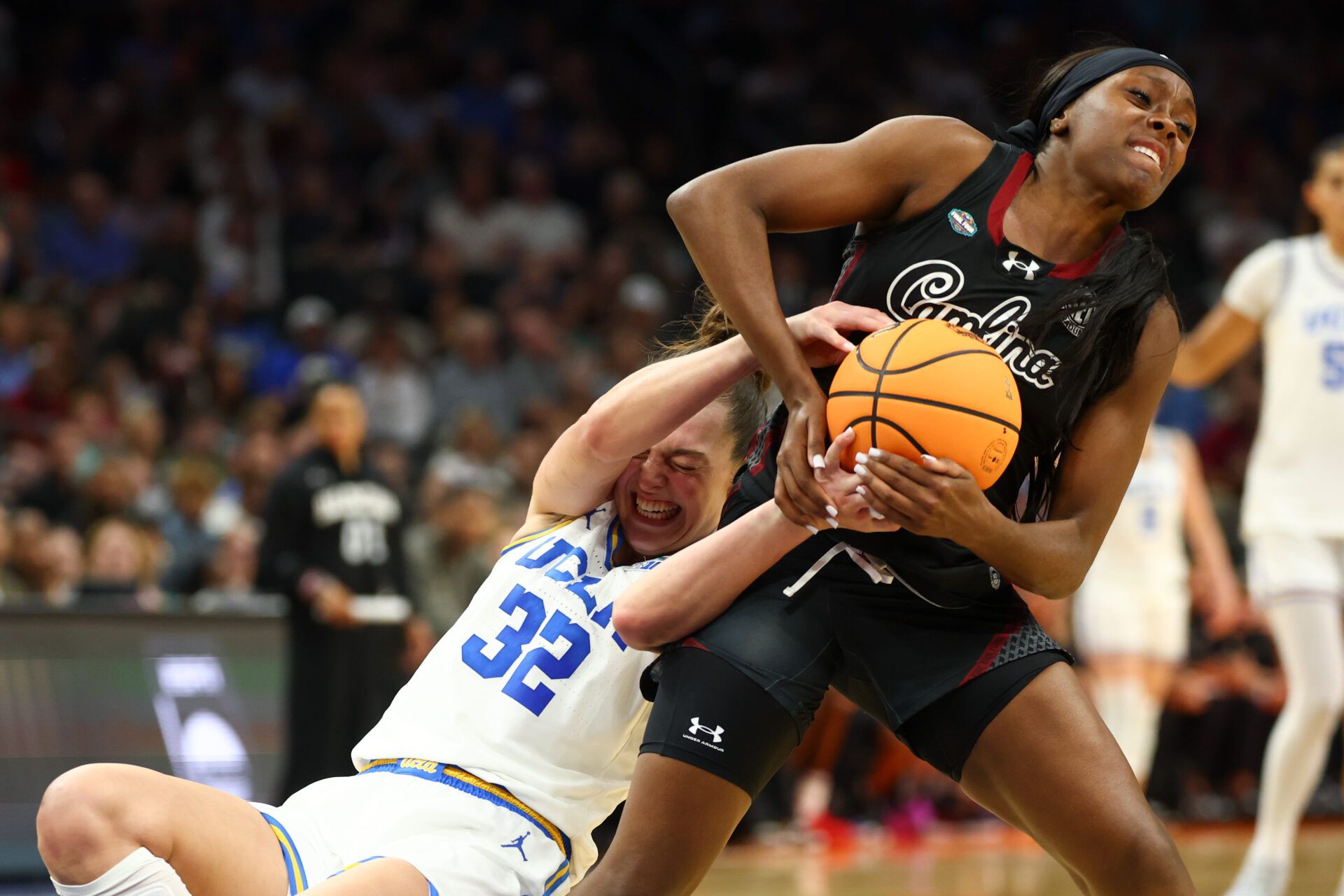 UCLA Bruins forward Angela Dugalic (32) and South Carolina Gamecocks guard Raven Johnson (25) battle for the ball in the second quarter during the National Championship game of the women's 2026 NCAA Tournament at Mortgage Matchup Center.
