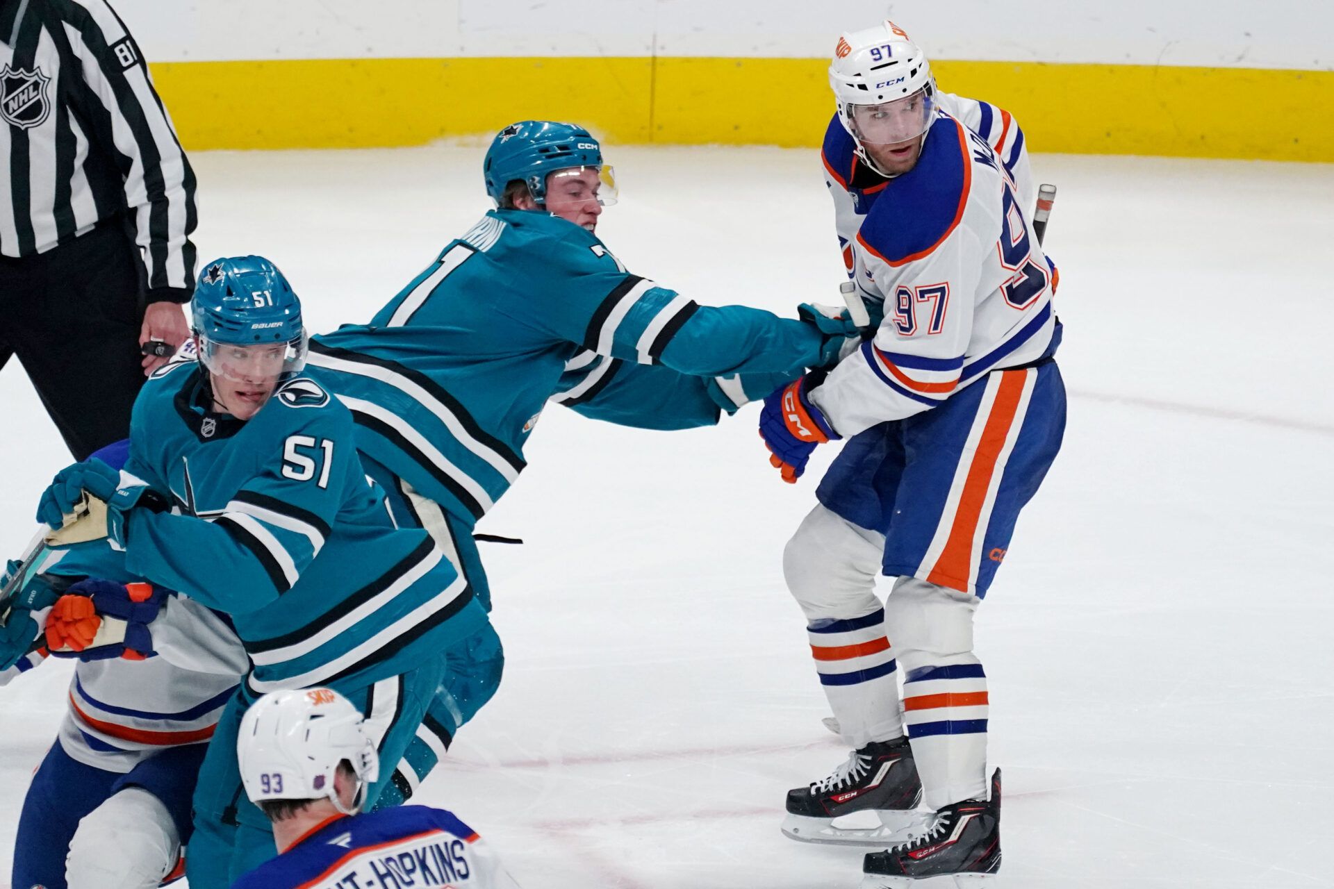 San Jose Sharks center Macklin Celebrini (71) and right wing Collin Graf (51) battle Edmonton Oilers center Connor McDavid (97) in the third period at SAP Center at San Jose.