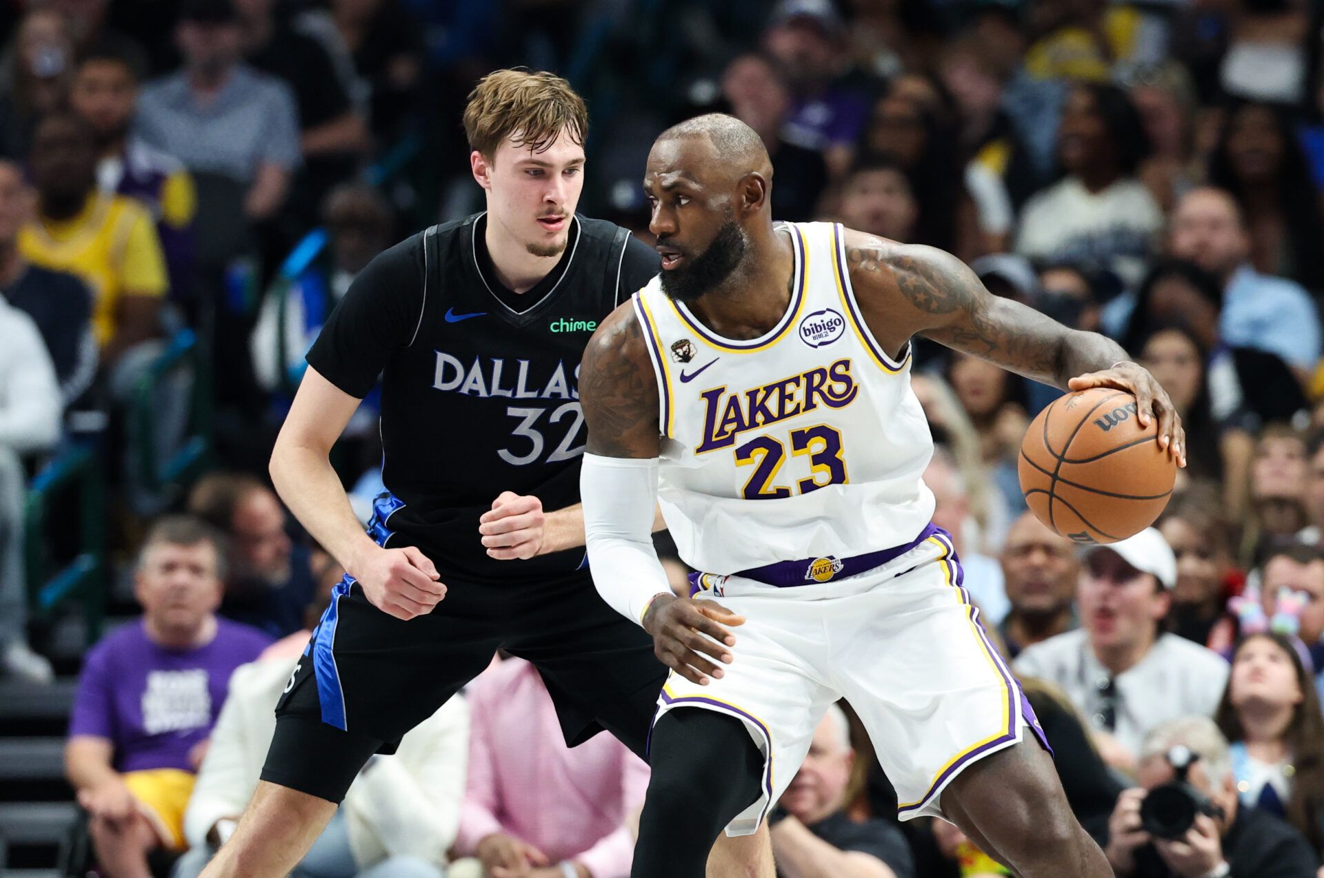Los Angeles Lakers forward LeBron James (23) controls the ball as  Dallas Mavericks forward Cooper Flagg (32) defends during the first half at American Airlines Center.