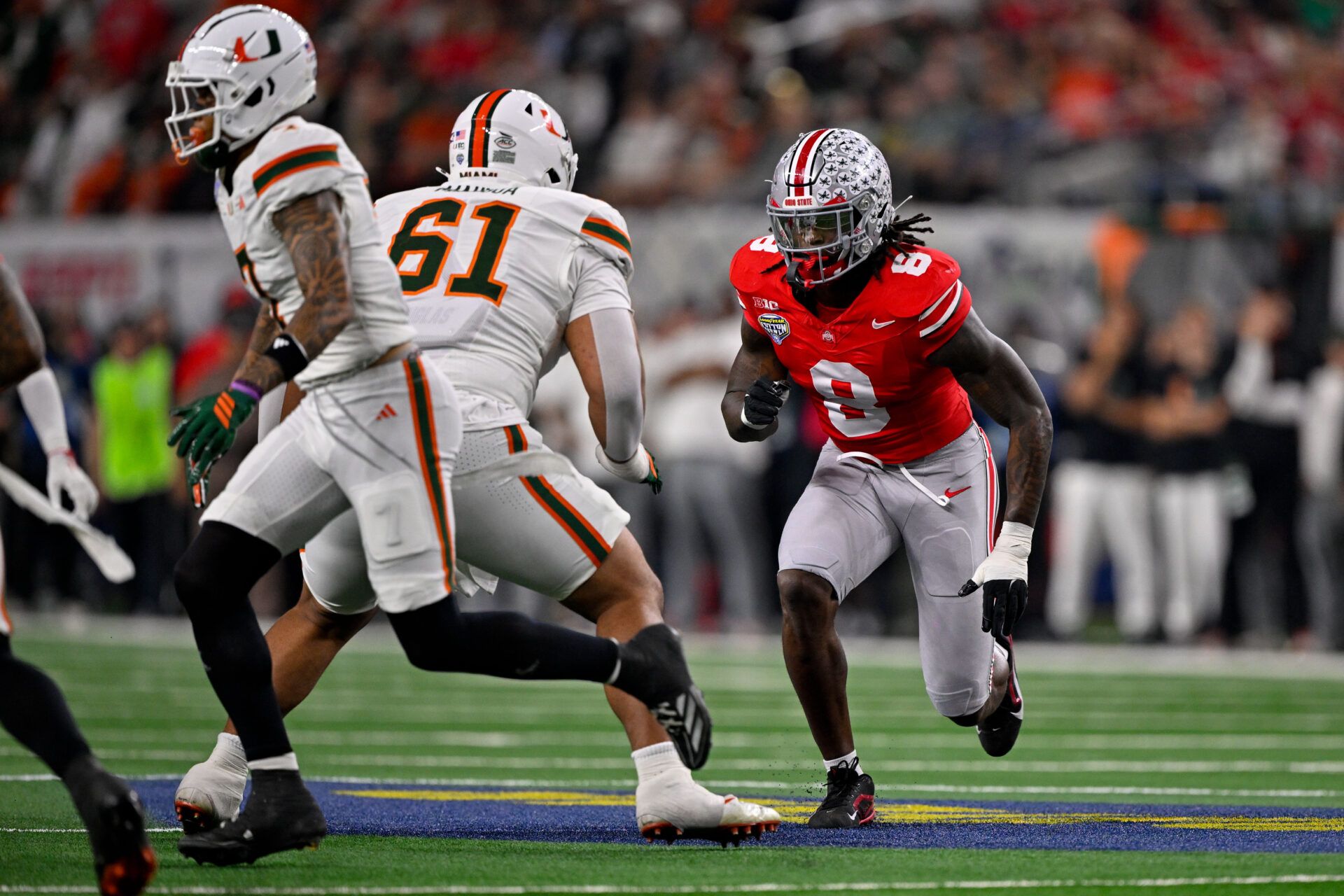 Miami Hurricanes offensive lineman Francis Mauigoa (61) blocks Ohio State Buckeyes linebacker Arvell Reese (8) during the 2025 Cotton Bowl and quarterfinal game of the College Football Playoff at AT&T Stadium.
