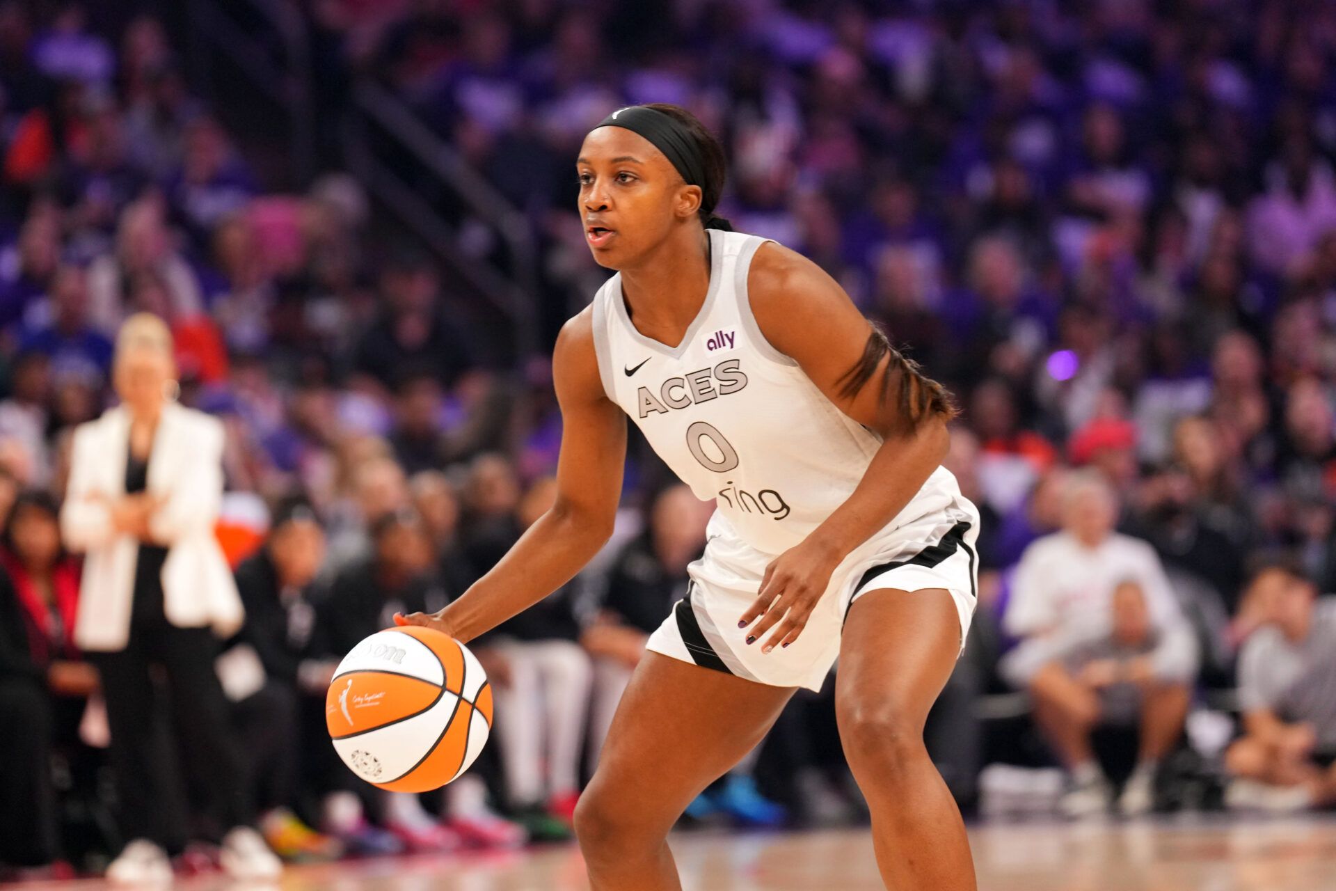 Las Vegas Aces guard Jackie Young (0) controls the ball against the Phoenix Mercury during the first half of game four of the 2025 WNBA Finals at Mortgage Matchup Center.