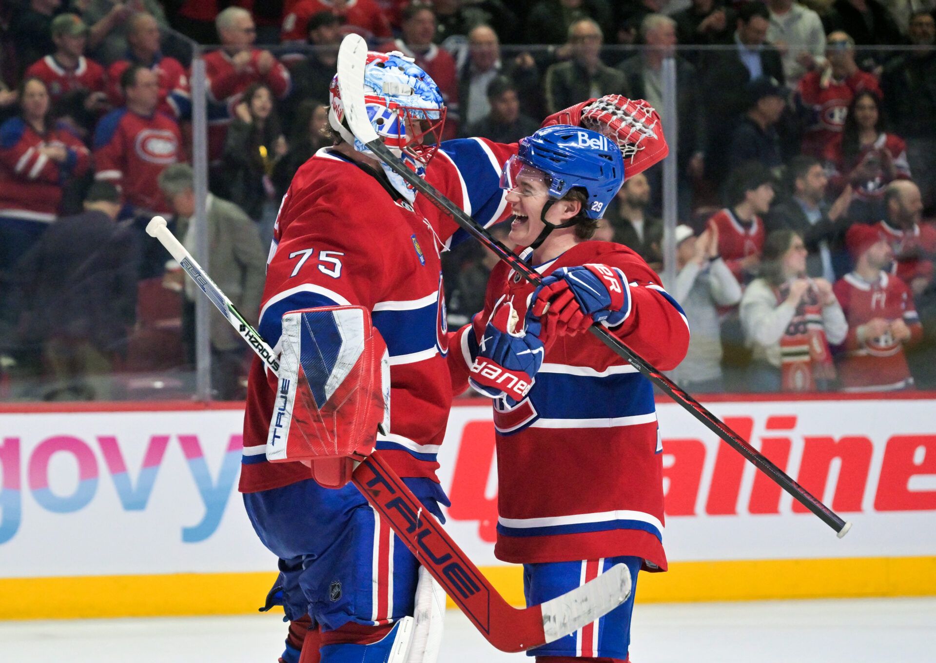 Montreal Canadiens goalie Jakub Dobes (75) and teammate forward Cole Caufield (13) celebrate the win against the Tampa Bay Lightning at the Bell Centre.