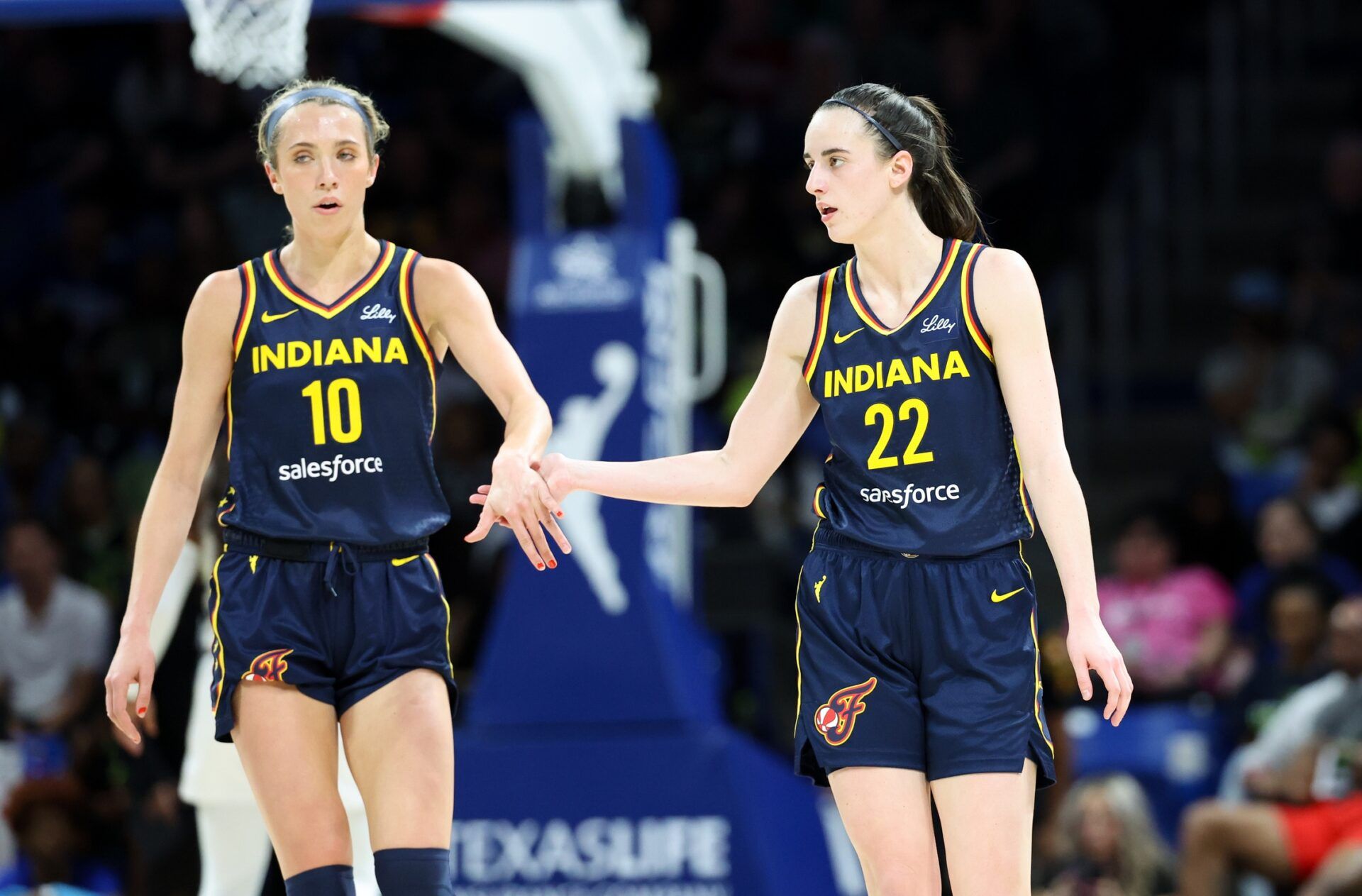 Indiana Fever guard Caitlin Clark (22) celebrates with Indiana Fever guard Lexie Hull (10) during the second quarter against the Dallas Wings at College Park Center.