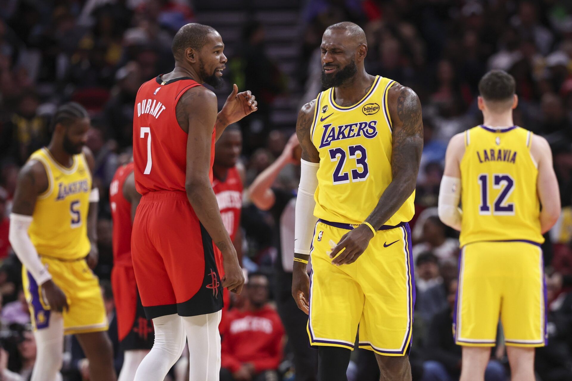 Houston Rockets forward Kevin Durant (7) talks with Los Angeles Lakers forward LeBron James (23) on the court during the second quarter at Toyota Center.