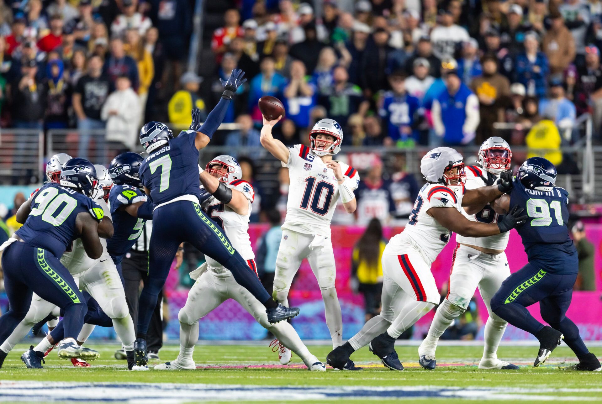 New England Patriots quarterback Drake Maye (10) throws a pass under pressure from Seattle Seahawks linebacker Uchenna Nwosu (7) during Super Bowl LX at Levi's Stadium.