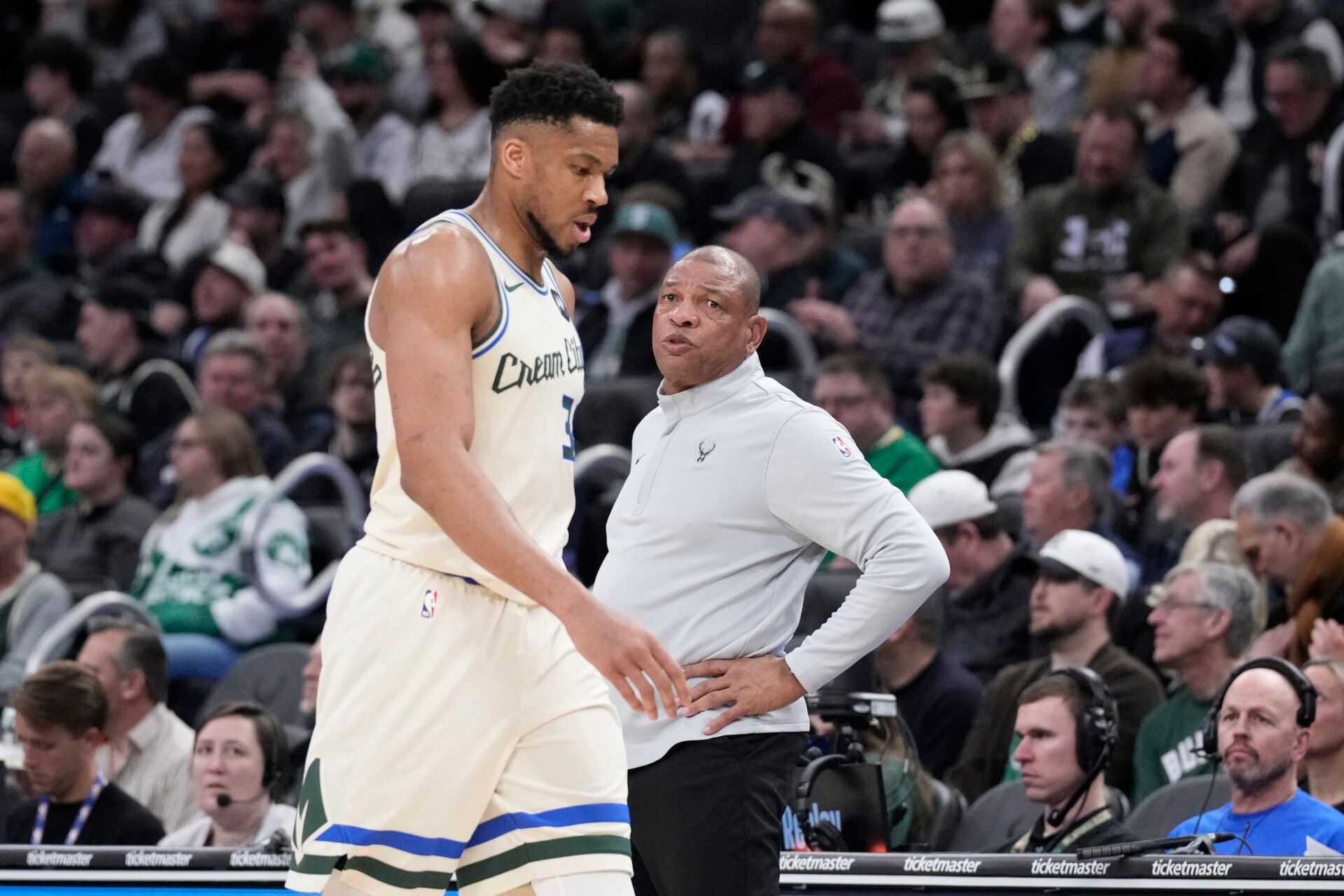 Milwaukee Bucks forward Giannis Antetokounmpo (34) comes out of the game near the end of the second quarter and walks past Milwaukee Bucks head coach Doc Rivers as they compete against the Boston Celtics at Fiserv Forum.