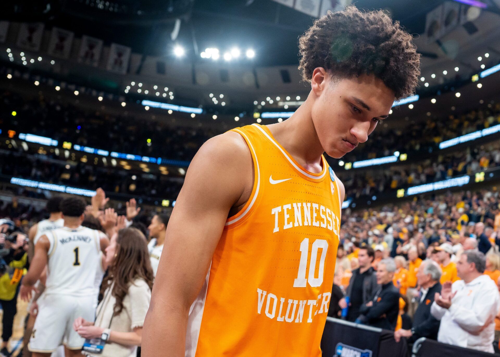 Tennessee forward Nate Ament (10) walks off the court as Michigan players celebrate their Final Four berth behind him after a NCAA Tournament Elite 8 game between Tennessee and Michigan at the United Center in Chicago on March 29, 2026.