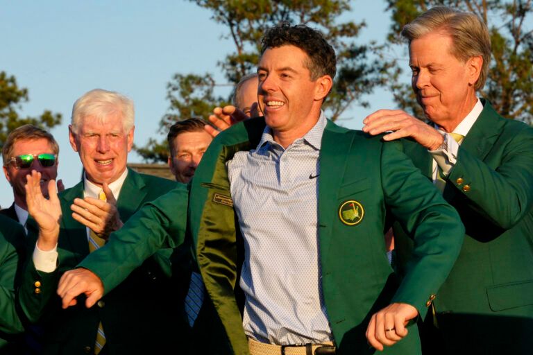Augusta National Golf Club chairman Fred Ridley places the green jacket on Rory McIlroy during the green jacket ceremony after the final round of the Masters Tournament at Augusta National Golf Club.