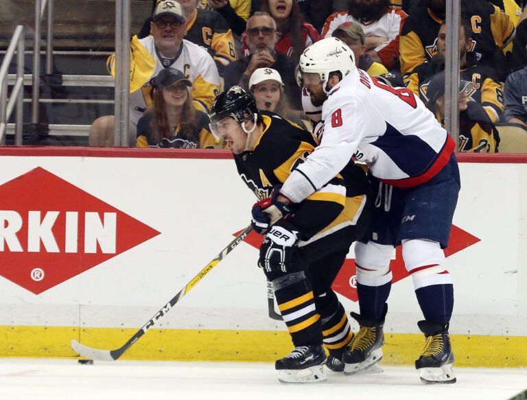 Pittsburgh Penguins center Evgeni Malkin (71) moves the puck against pressure from Washington Capitals left wing Alex Ovechkin (8) during the second period in game six of the second round of the 2018 Stanley Cup Playoffs at PPG PAINTS Arena. The Capitals won 2-1 in overtime to win the series 4 games to 2.