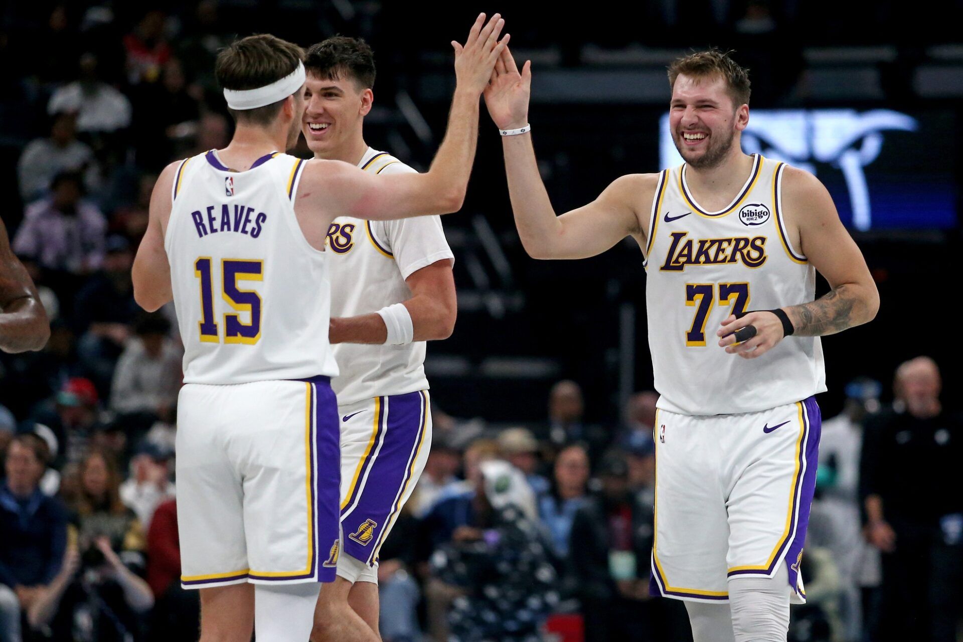 Los Angeles Lakers guard Luka Doncic (77) reacts with guard Austin Reaves (15) during a timeout during the second quarter against the Memphis Grizzlies at FedExForum.
