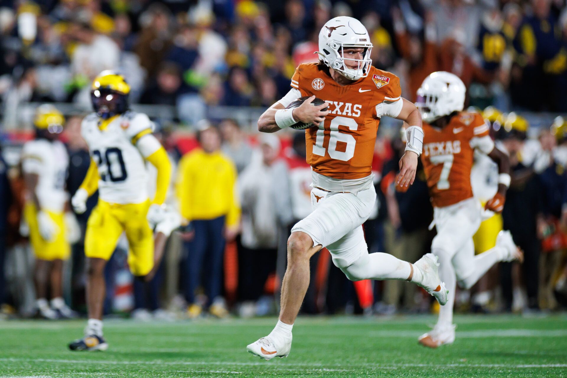 Texas Longhorns quarterback Arch Manning (16) rushes with the ball for a touchdown against the Michigan Wolverines during the second half at Camping World Stadium.