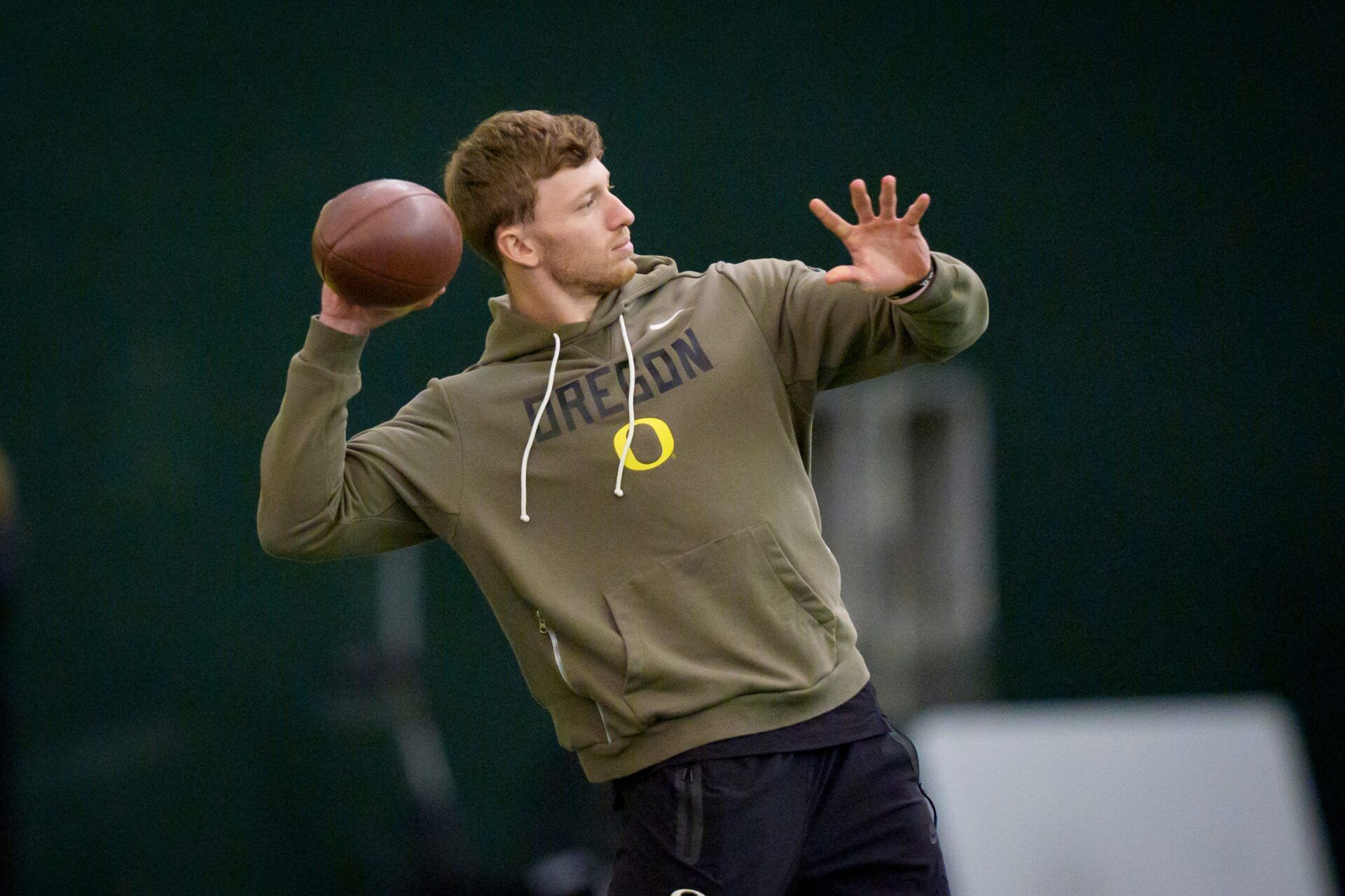 Oregon defensive back Dillon Thieneman helps inside linebacker Bryce Boettcher warm up during Oregon Pro Day on March 17, 2026, at the Moshofsky Center in Eugene, Oregon.