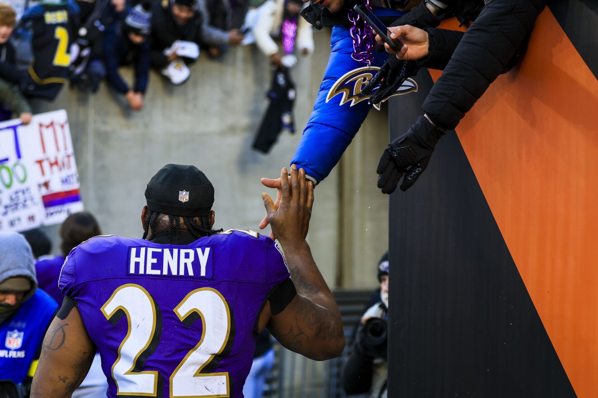 Baltimore Ravens running back Derrick Henry (22) high fives fans after the victory over the Cincinnati Bengals at Paycor Stadium.