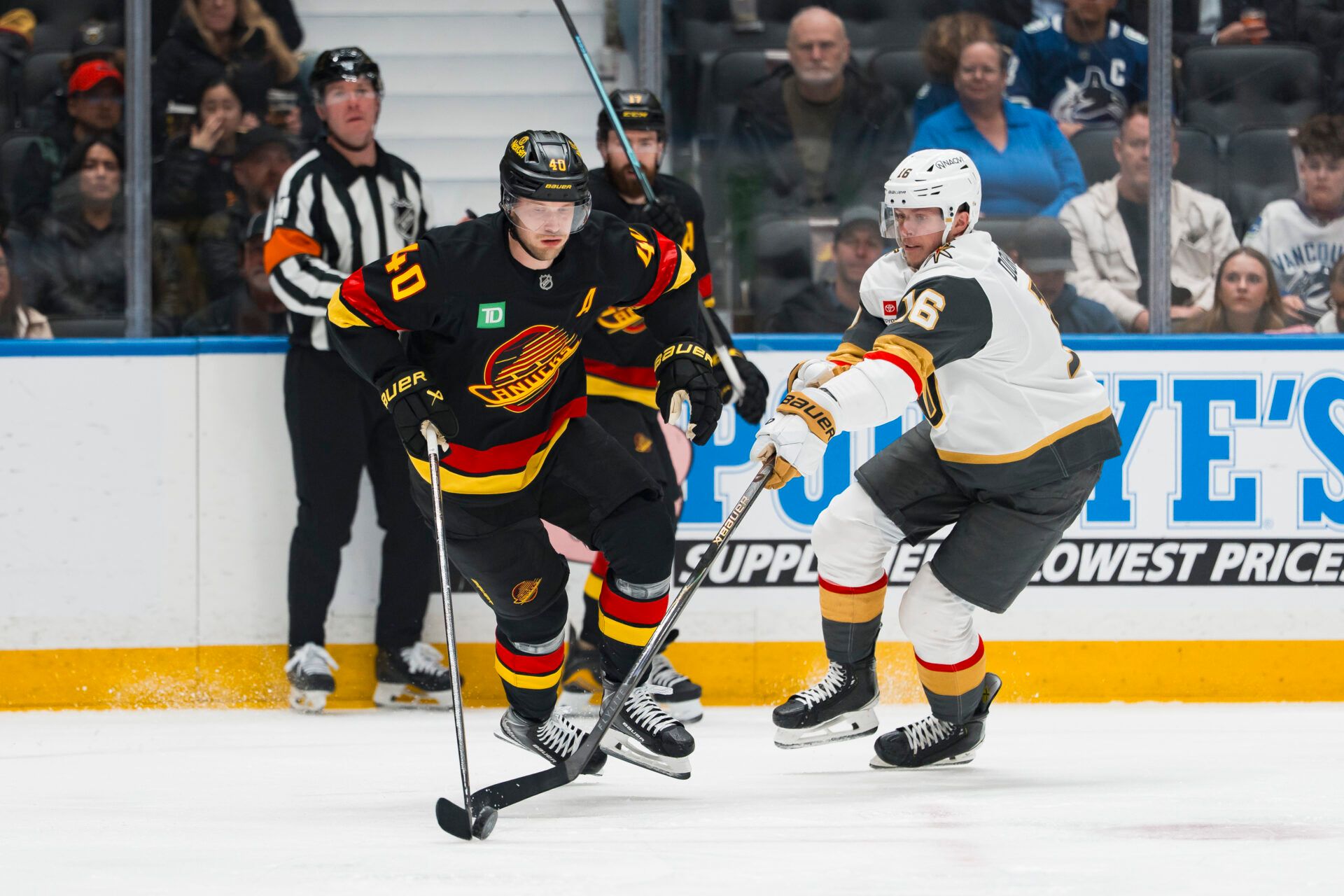 Vegas Golden Knights forward Pavel Dorofeyev (16) stick checks Vancouver Canucks forward Elias Pettersson (40) in the first period at Rogers Arena.