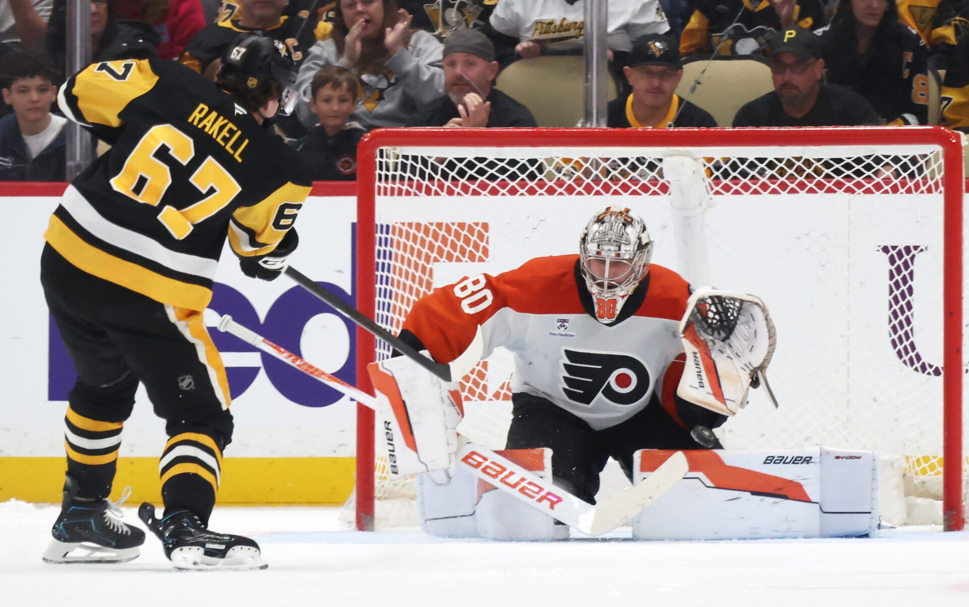 Philadelphia Flyers goaltender Dan Vladar (80) makes a save against Pittsburgh Penguins right wing Rickard Rakell (67) in a shootout at PPG Paints Arena.