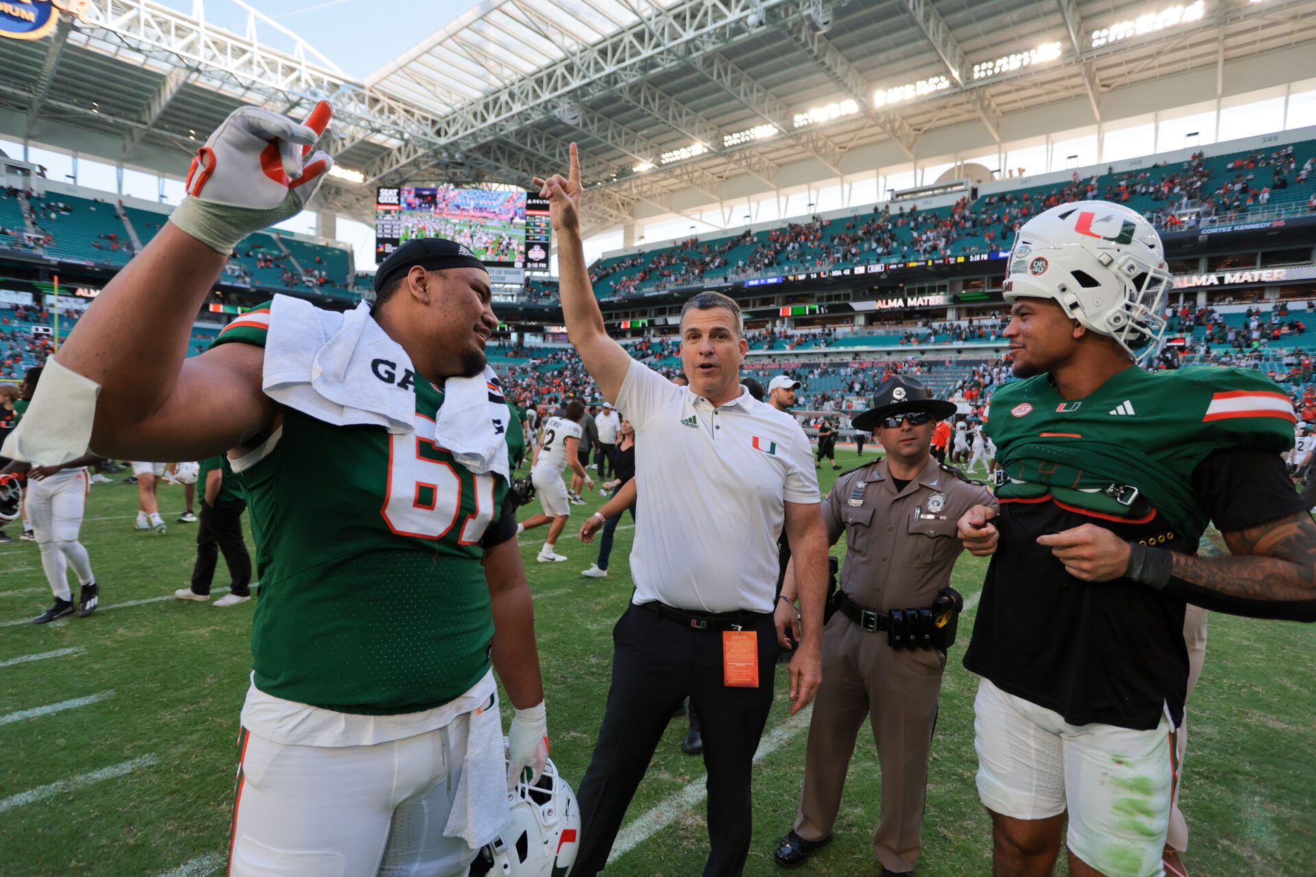 Miami Hurricanes head coach Mario Cristobal celebrates with Miami Hurricanes offensive lineman Francis Mauigoa (61) and tight end Elijah Arroyo (8) after the game against the Wake Forest Demon Deacons at Hard Rock Stadium.