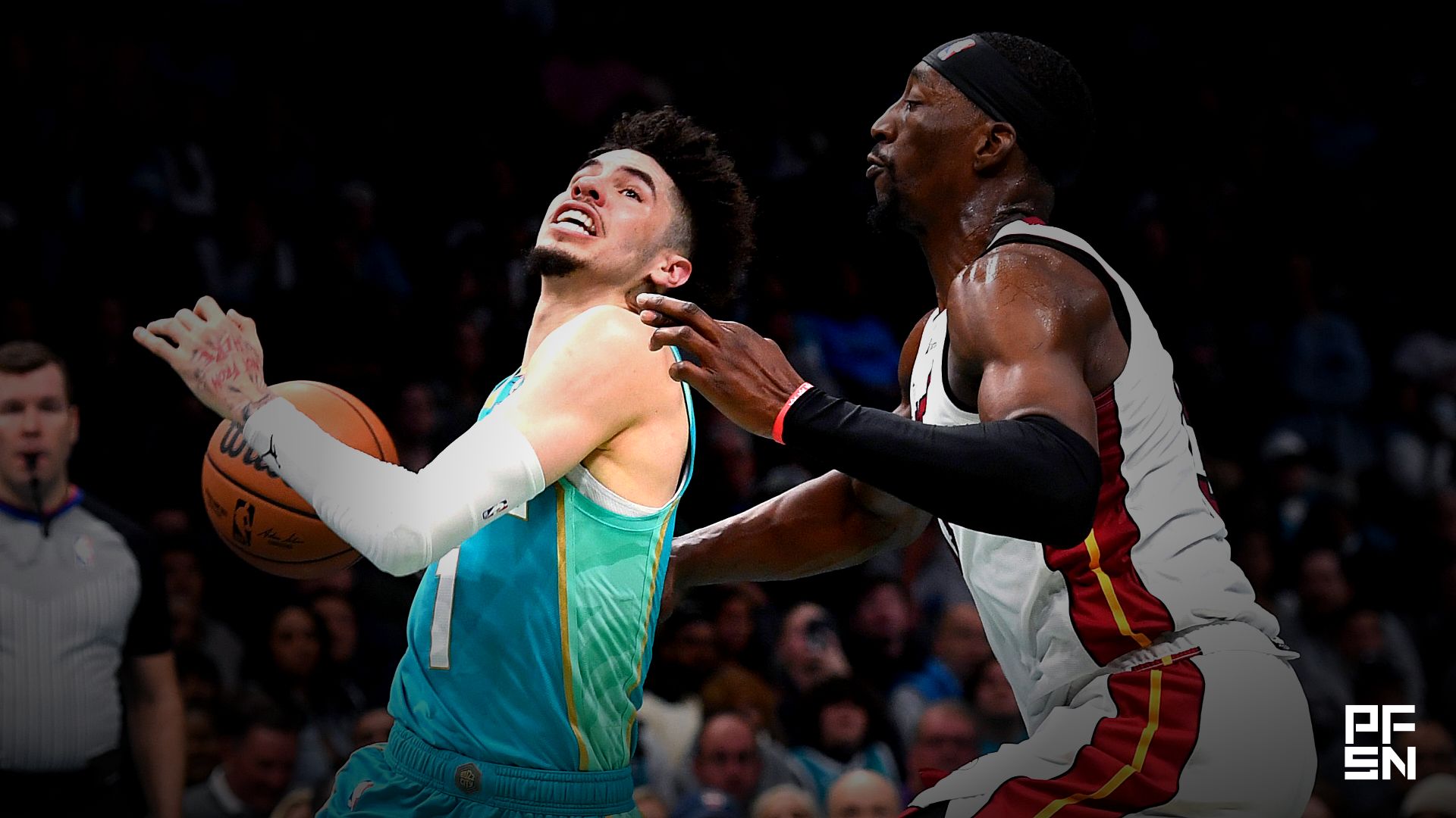 Charlotte Hornets guard LaMelo Ball (1) drives past Miami Heat center forward Bam Adebayo (13) during the second half at the Spectrum Center.