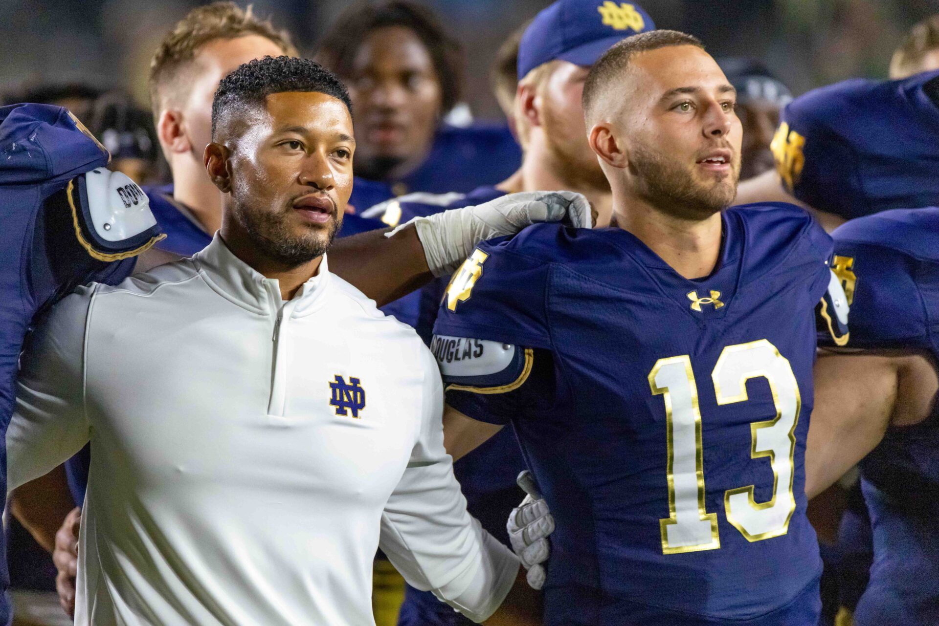 Notre Dame Fighting Irish head coach Marcus Freeman and quarterback CJ Carr (13) sing the alma mater after beating the Purdue Boilermakers at Notre Dame Stadium.