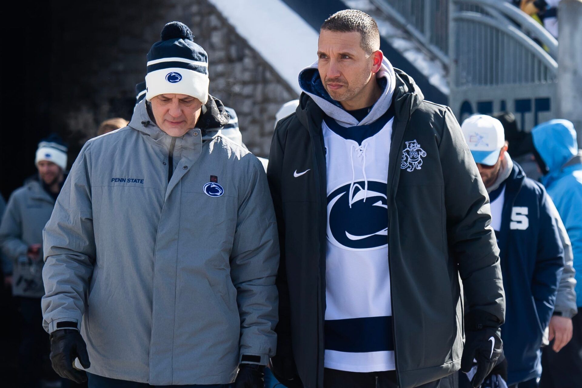 First-year Penn State football head coach Matt Campbell, right, walks into Beaver Stadium for a top-five Big Ten ice hockey game against Michigan State in Beaver Stadium on January 31, 2026, in State College.